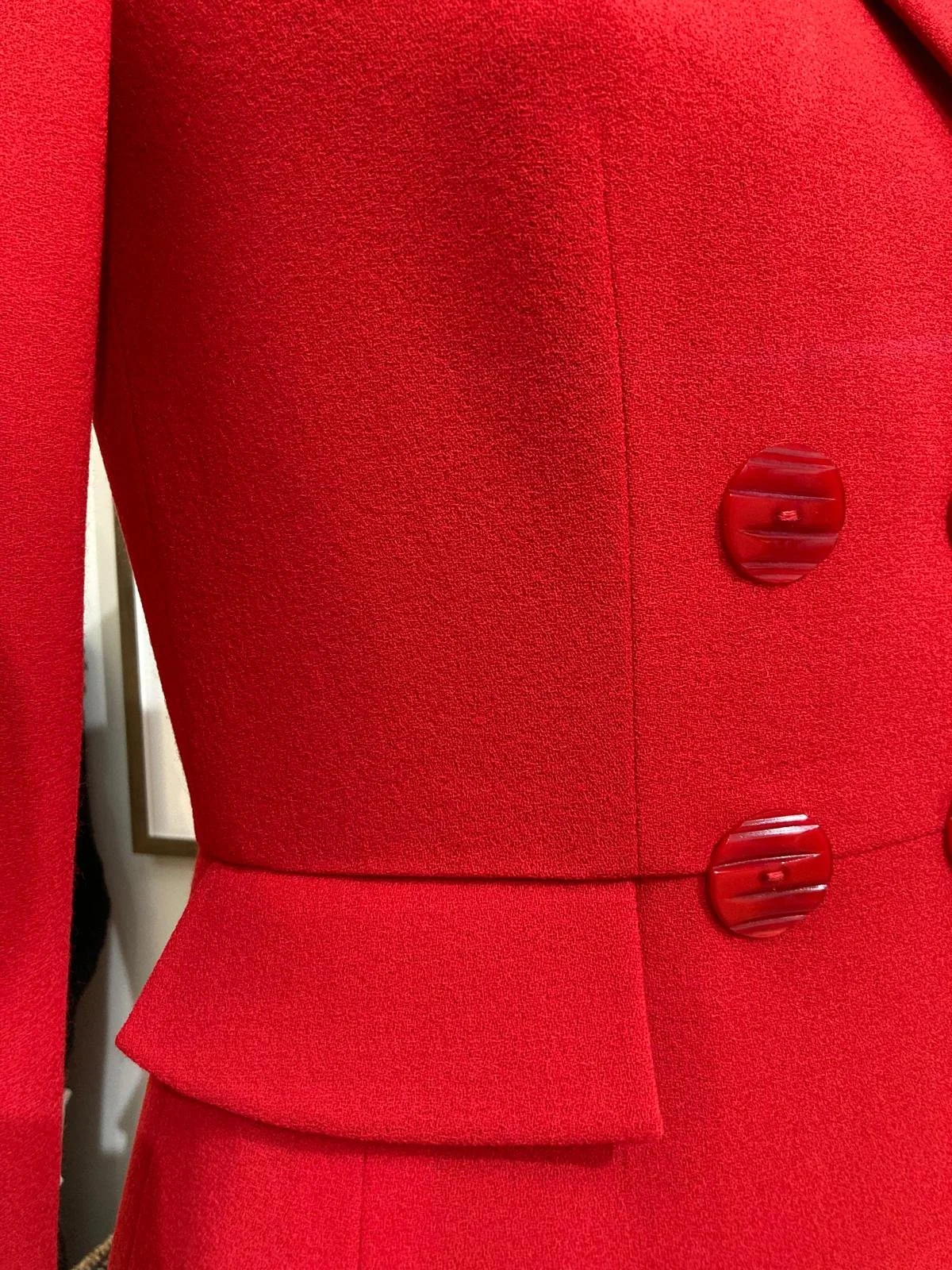 Finished bespoke red coat dress with close up of pocket