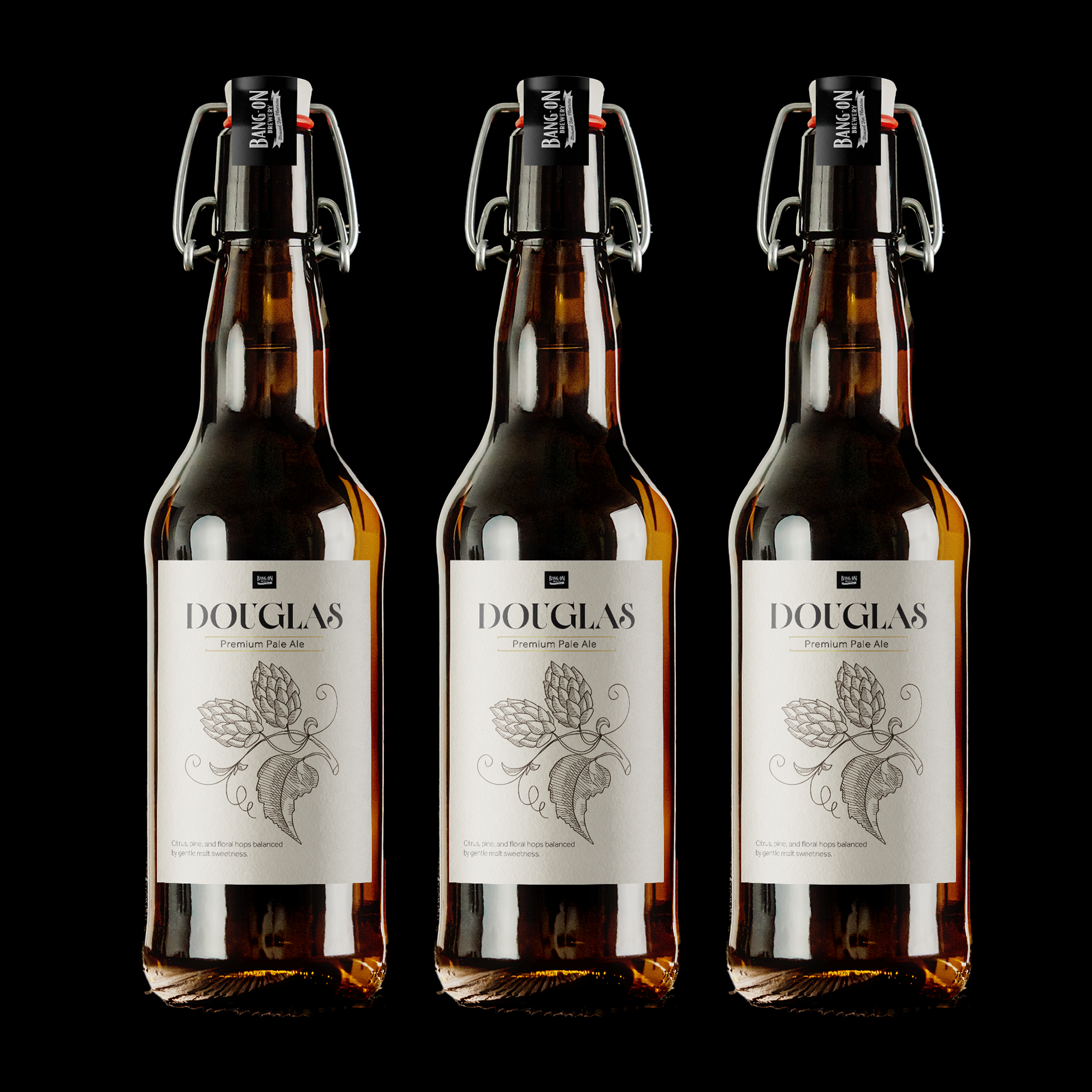 Three bottles of Douglas premium pale ale with flip-top caps, set against a black background.