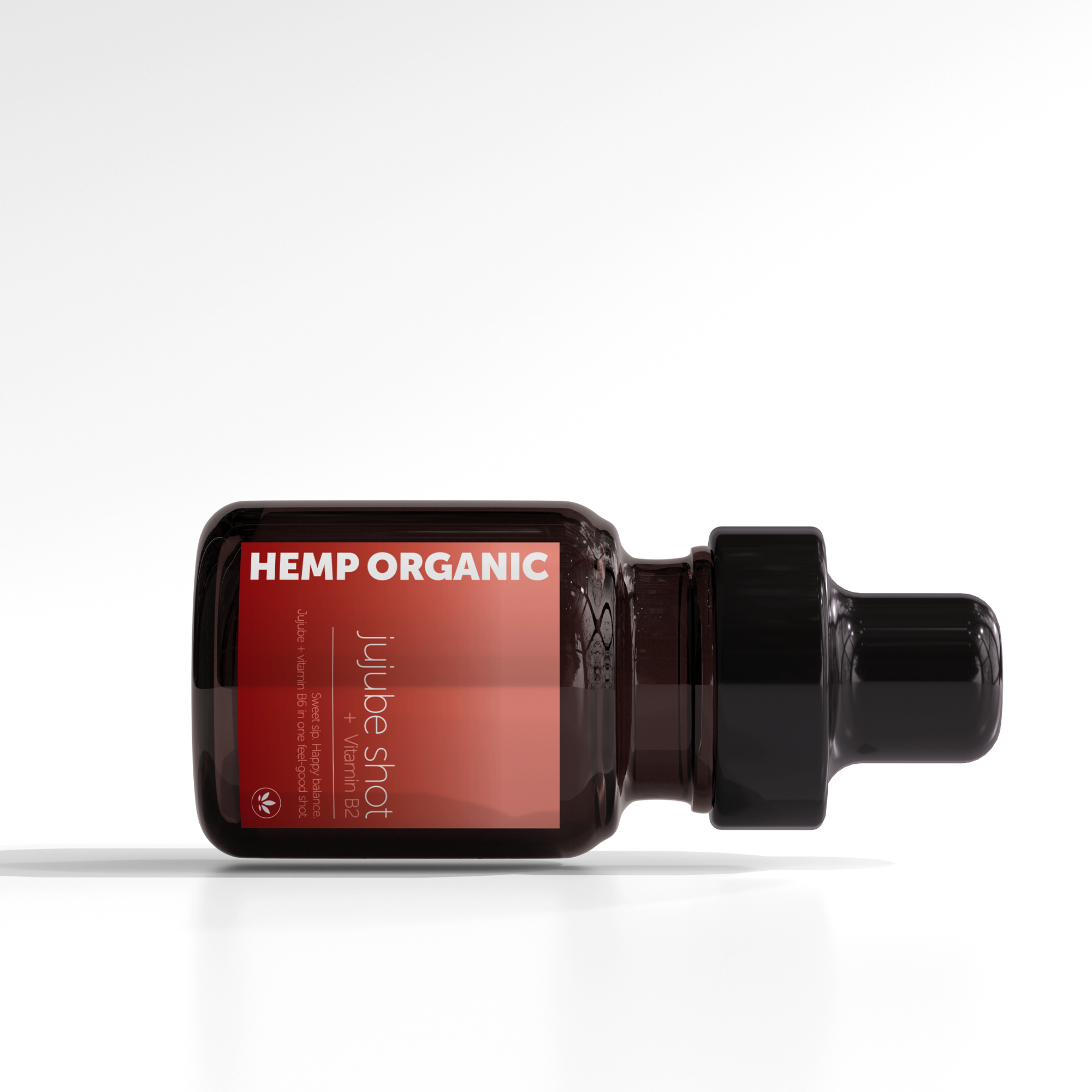 A dark amber glass bottle labeled 'Hemp Organic' lying on a white surface, with a black dropper cap and red label indicating 'Juice Shot' with ingredients list.