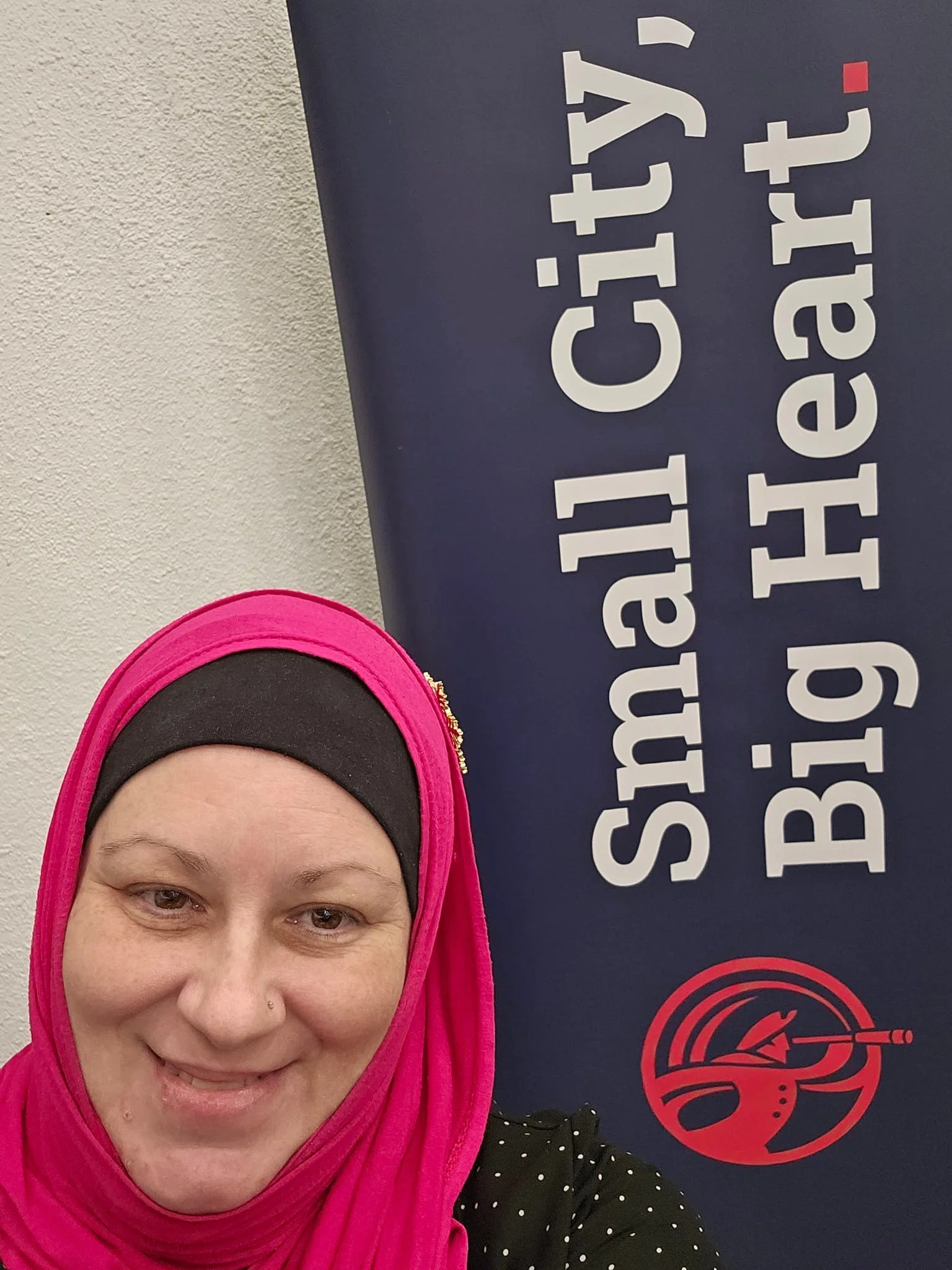 Paula with the new city brand-Small City, Big Heart.