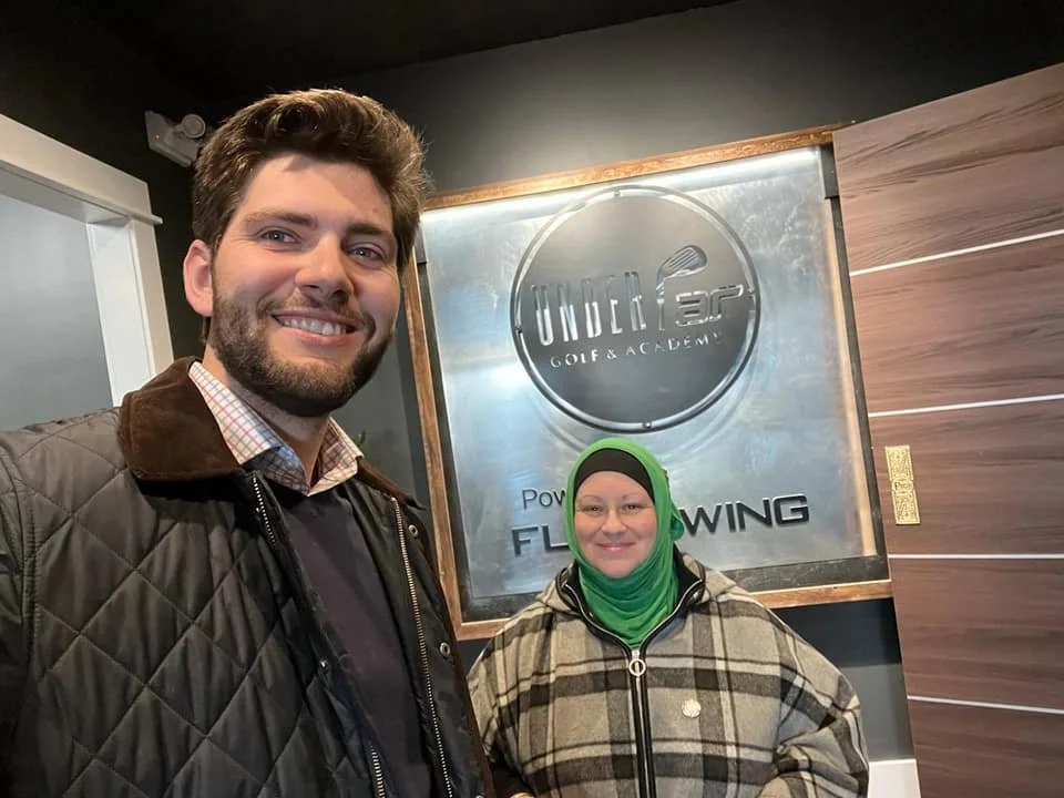 David Hickey and Paula at the grand opening  of Under Par Golf and Academy. David showed his golfing techniques while Paula showed her lack of skill. 