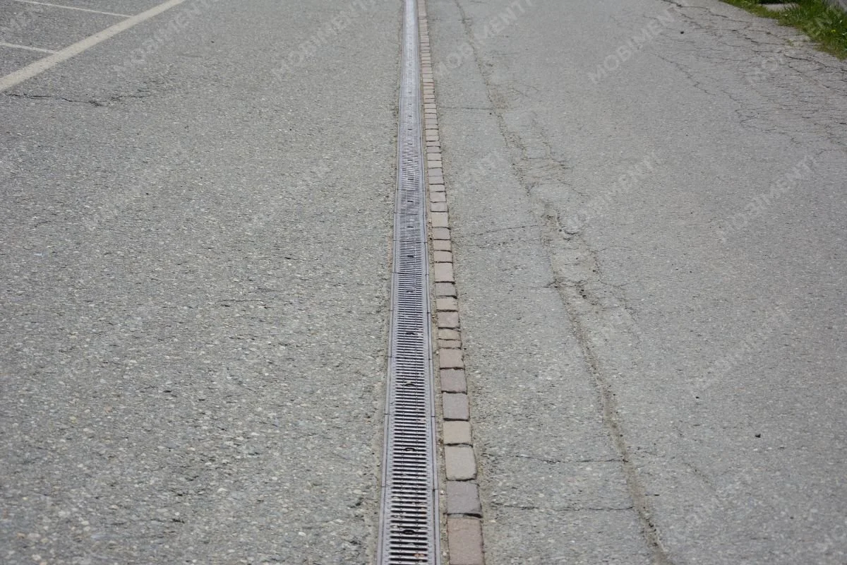 Entwässerungsrinne auf Asphaltfläche