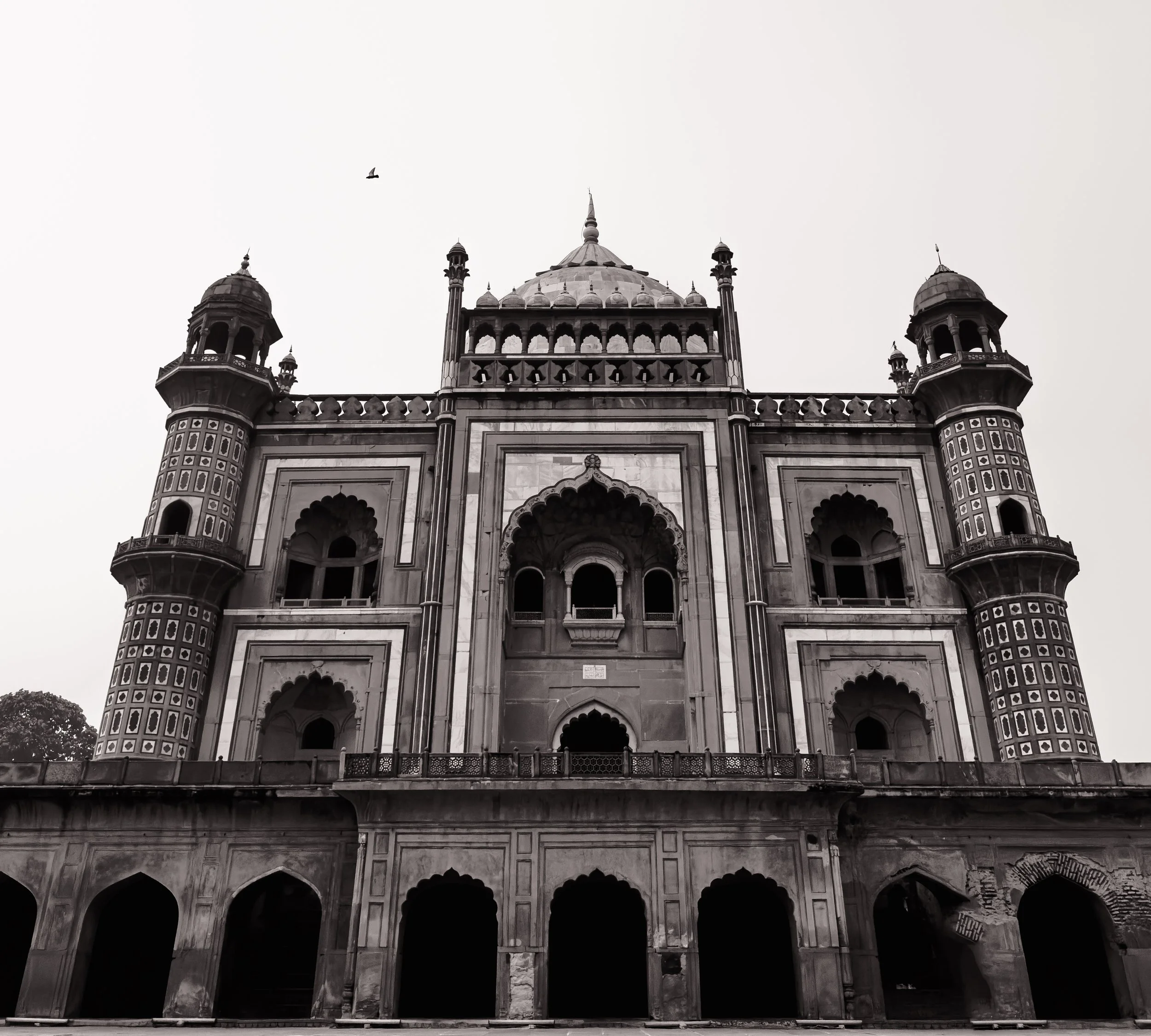 A historic building with domes and towers, featuring detailed architectural designs, in black and white.