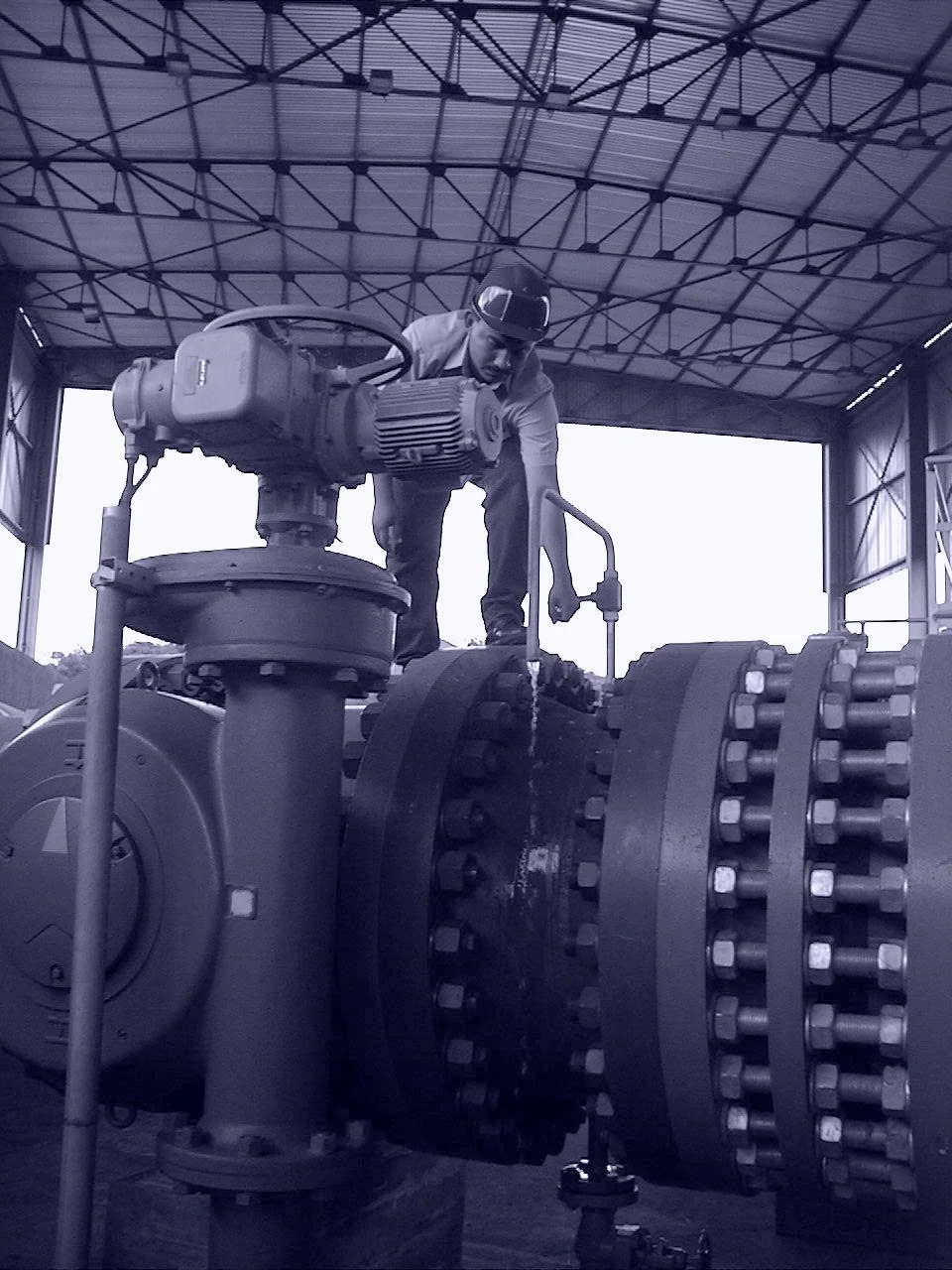 Technician operating a high-capacity gate valve inside a municipal water intake pump station.