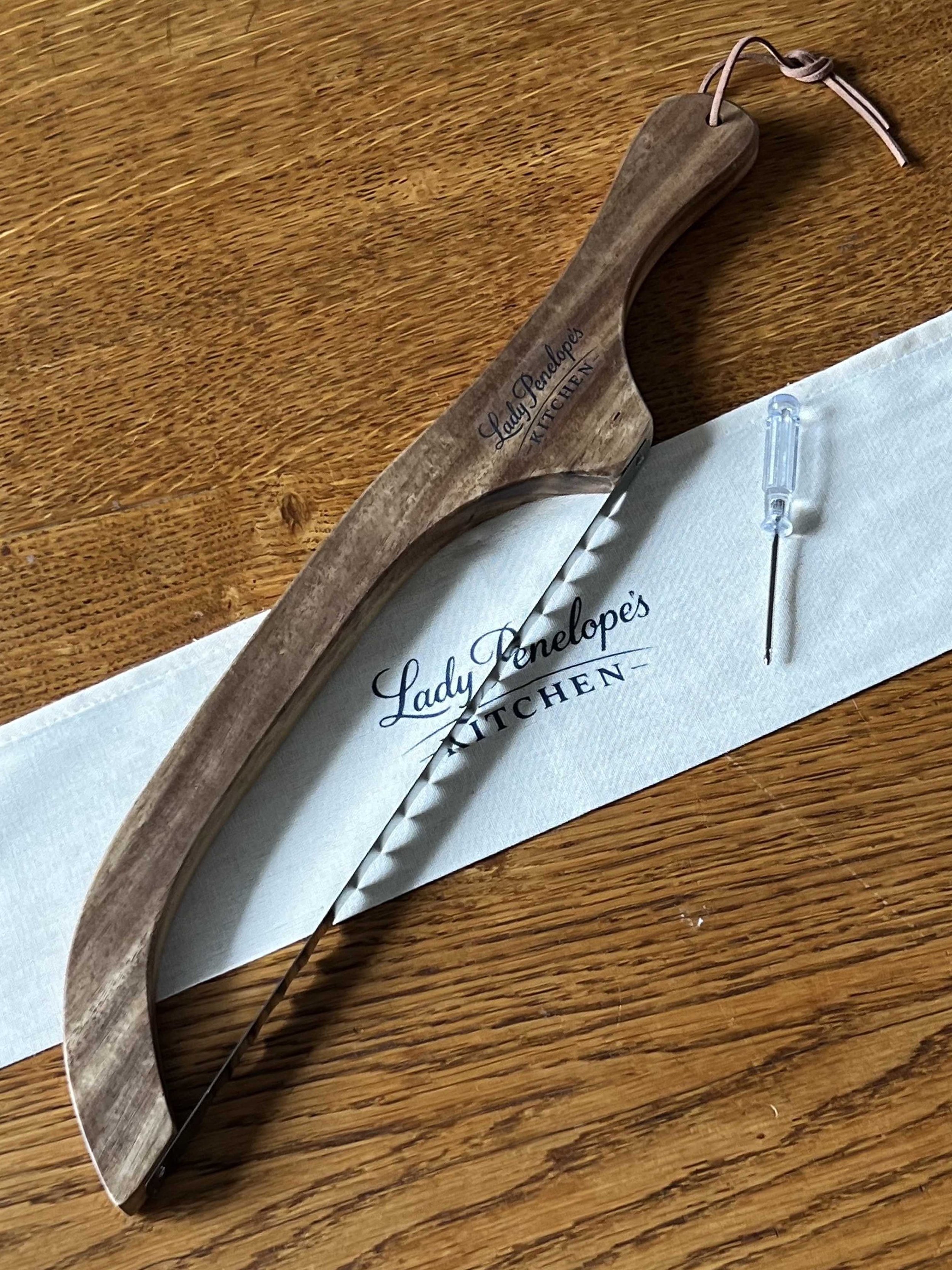 A wooden sourdough bow with a stainless steel blade