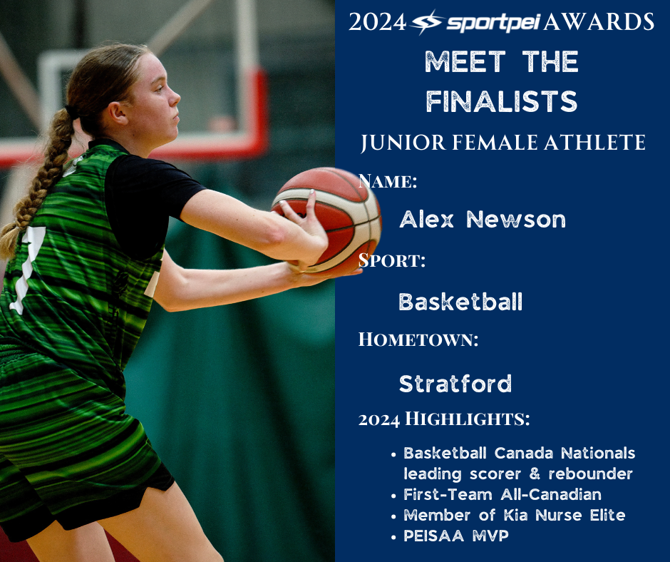 A young female basketball player in a green and black uniform holding a basketball on an indoor court.