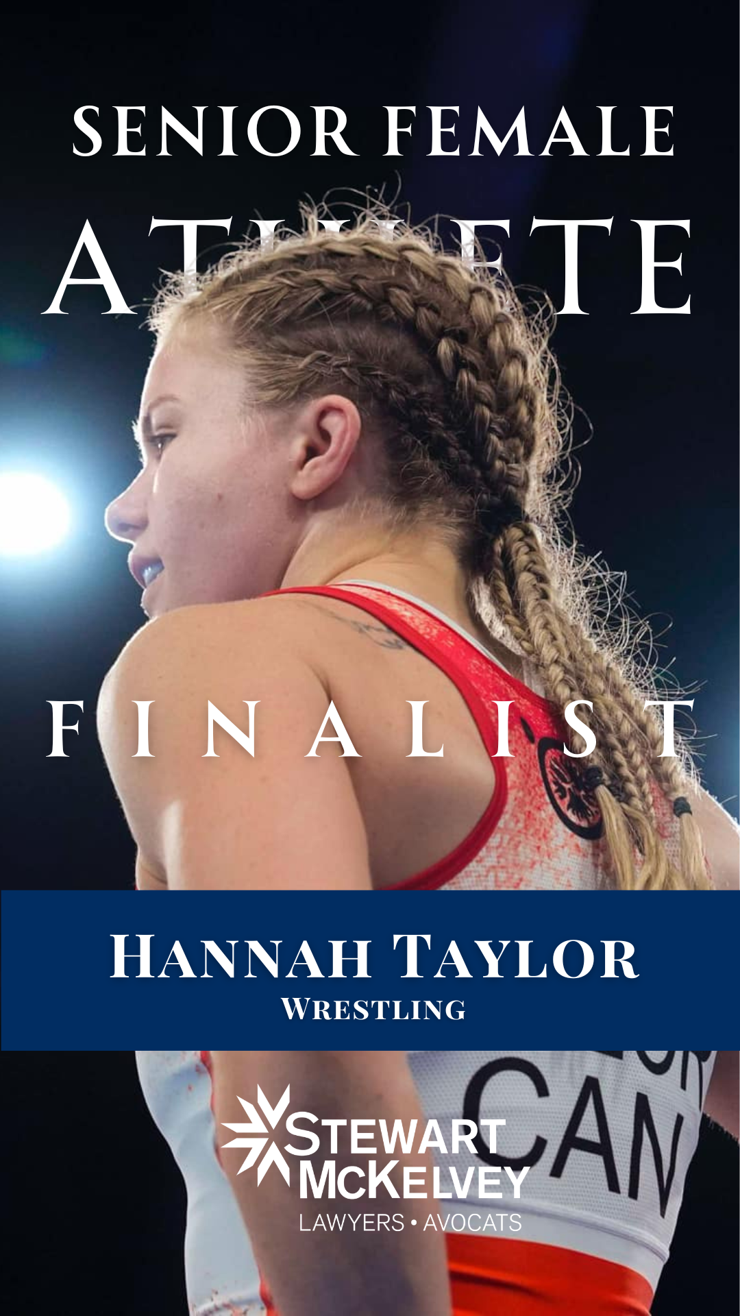 A young female wrestler with braided blonde hair and a tattoo on her shoulder, wearing a red and white wrestling uniform, during a competition.