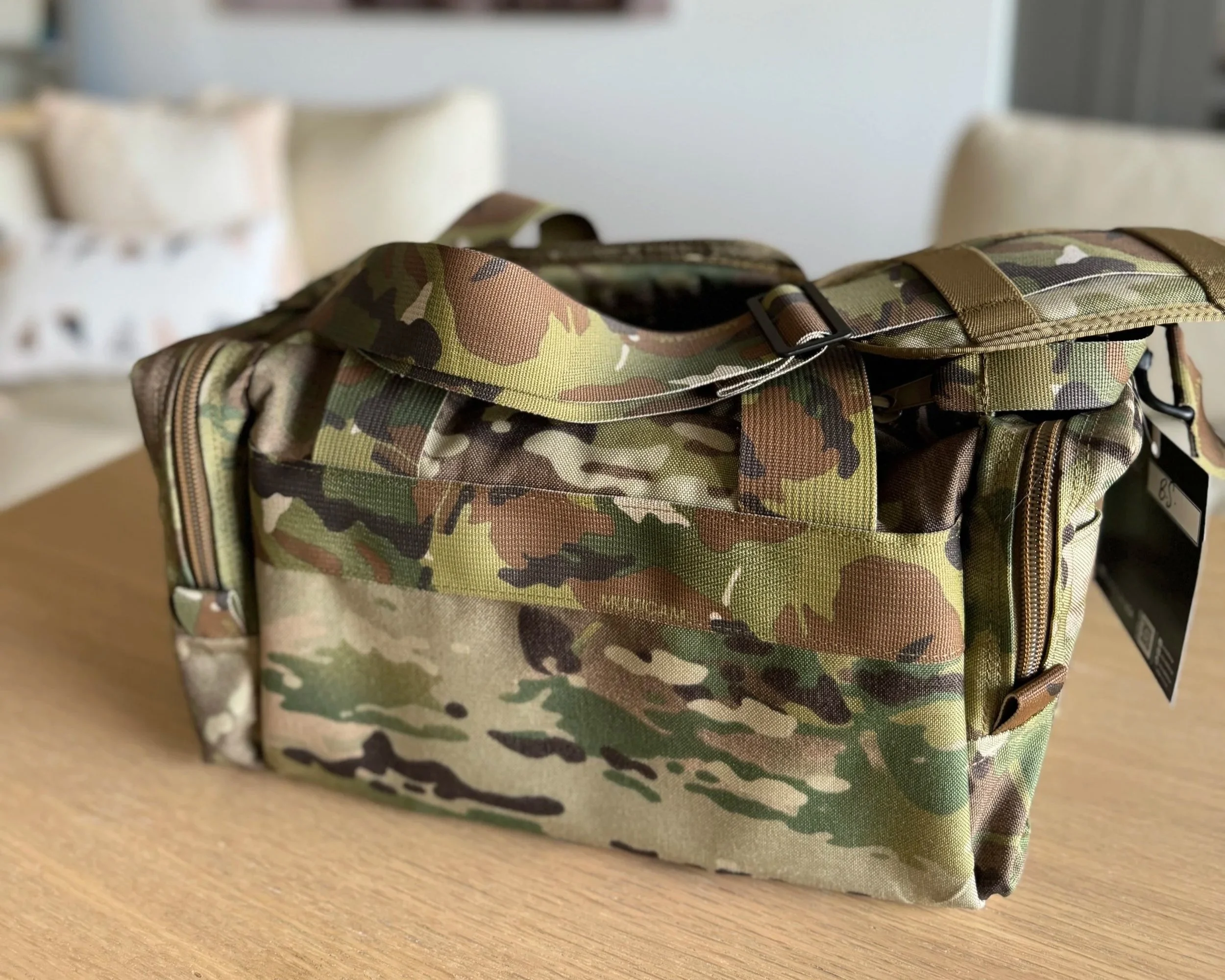 camo range bag on a wooden table