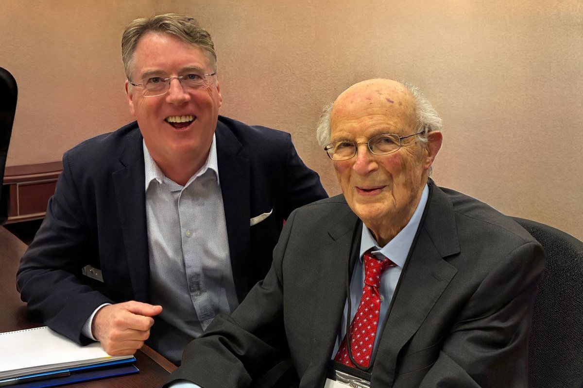 “Aidan Connolly and Professor Ray Goldberg seated together at the Harvard Agribusiness Summit, representing leadership and collaboration in global agribusiness.