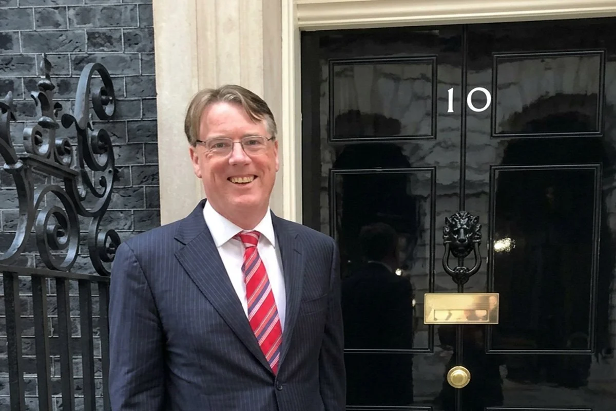 “Aidan Connolly standing outside the Number 10 Downing Street entrance, representing his advisory work with senior leaders and policymakers.