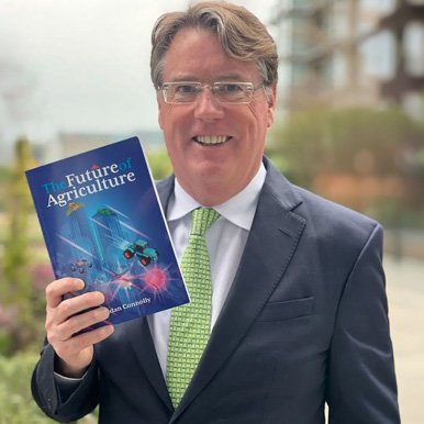 “Author holding ‘The Future of Agriculture’ book in an outdoor setting, representing thought leadership and global commentary on the future of food and farming.