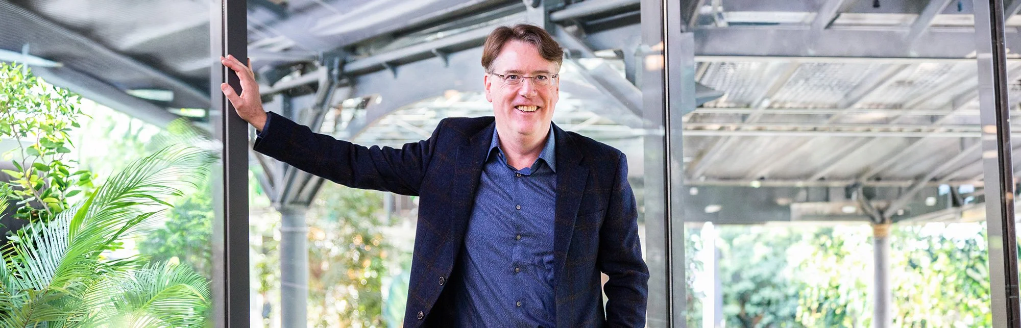 Aidan Connolly standing in a modern industrial setting, representing leadership and strategic guidance in global agriculture innovation.
