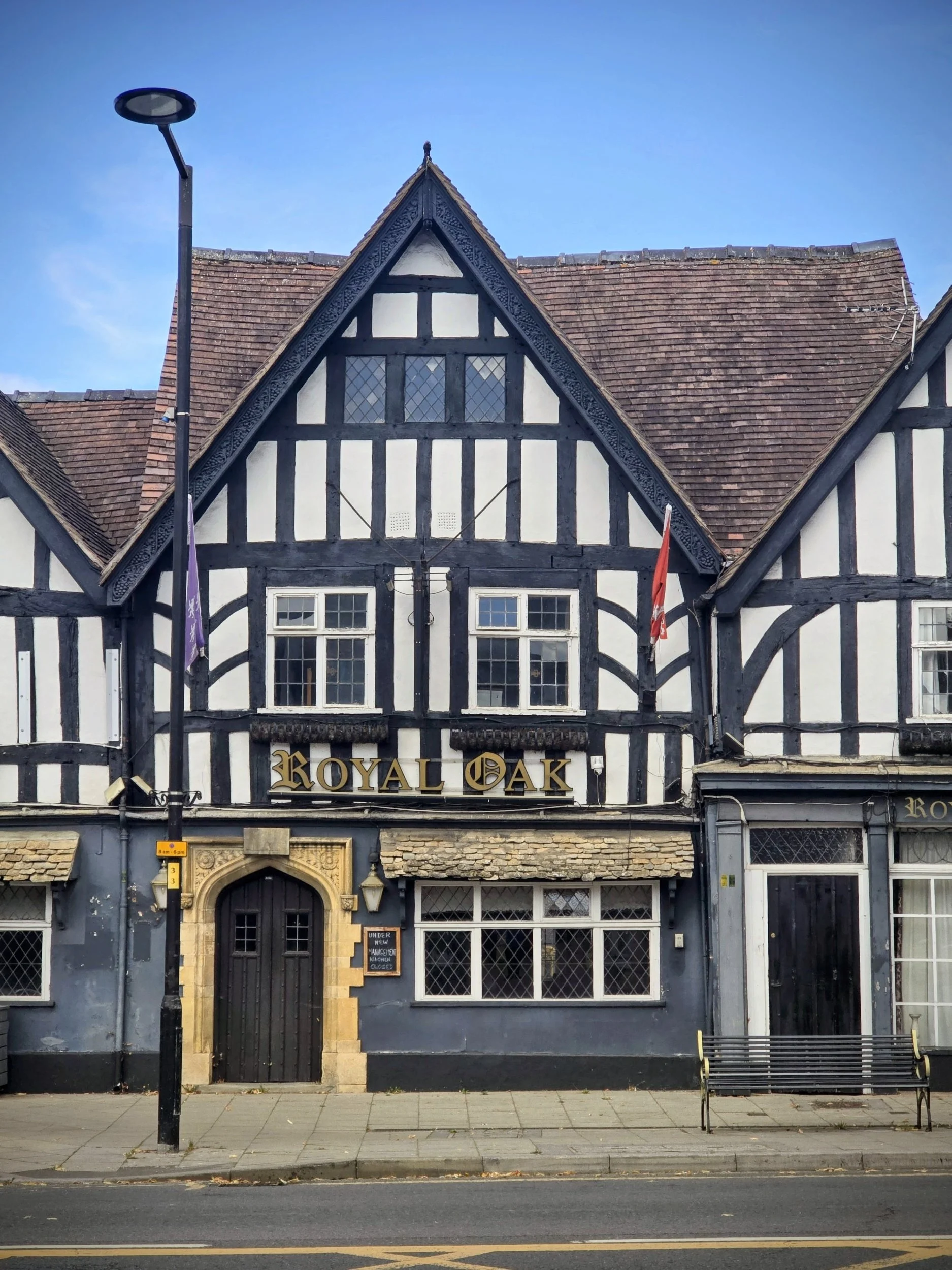 Exterior view of The Royal Oak, a traditional stone-built historic pub in the Evesham and Cotswolds region, featuring classic British architecture and outdoor seating.
