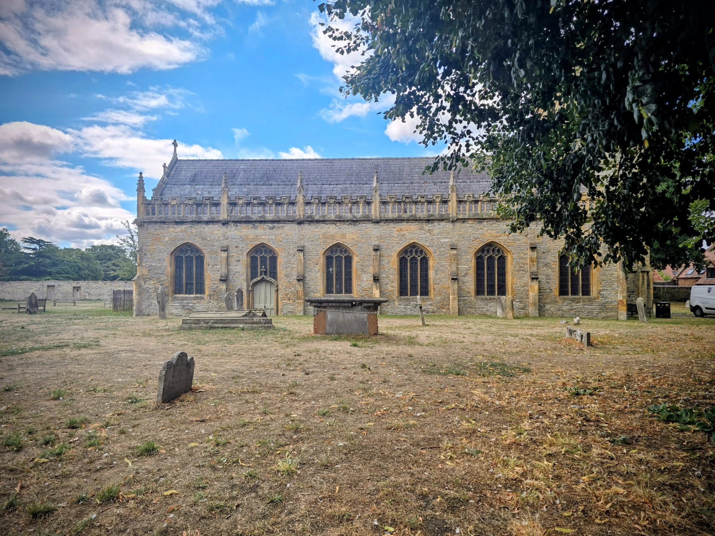The historic St Lawrence’s Church in Evesham, featuring 15th-century Gothic architecture, a majestic tower, and ornate stone-carved exterior details.