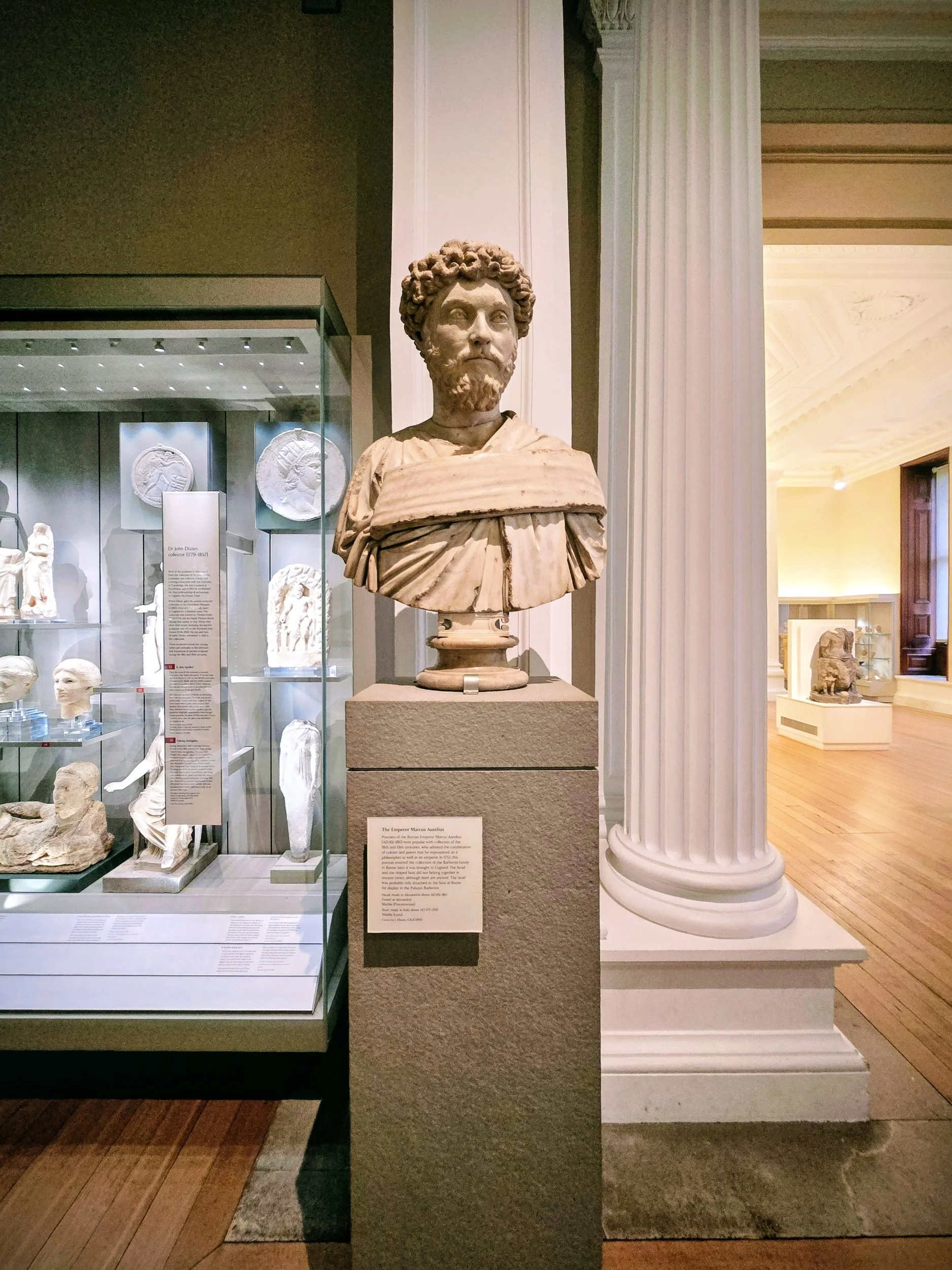 A marble bust of Marcus Aurelius stands in the Fitzwilliam Museum, reflecting Stoic wisdom through detailed Roman art.