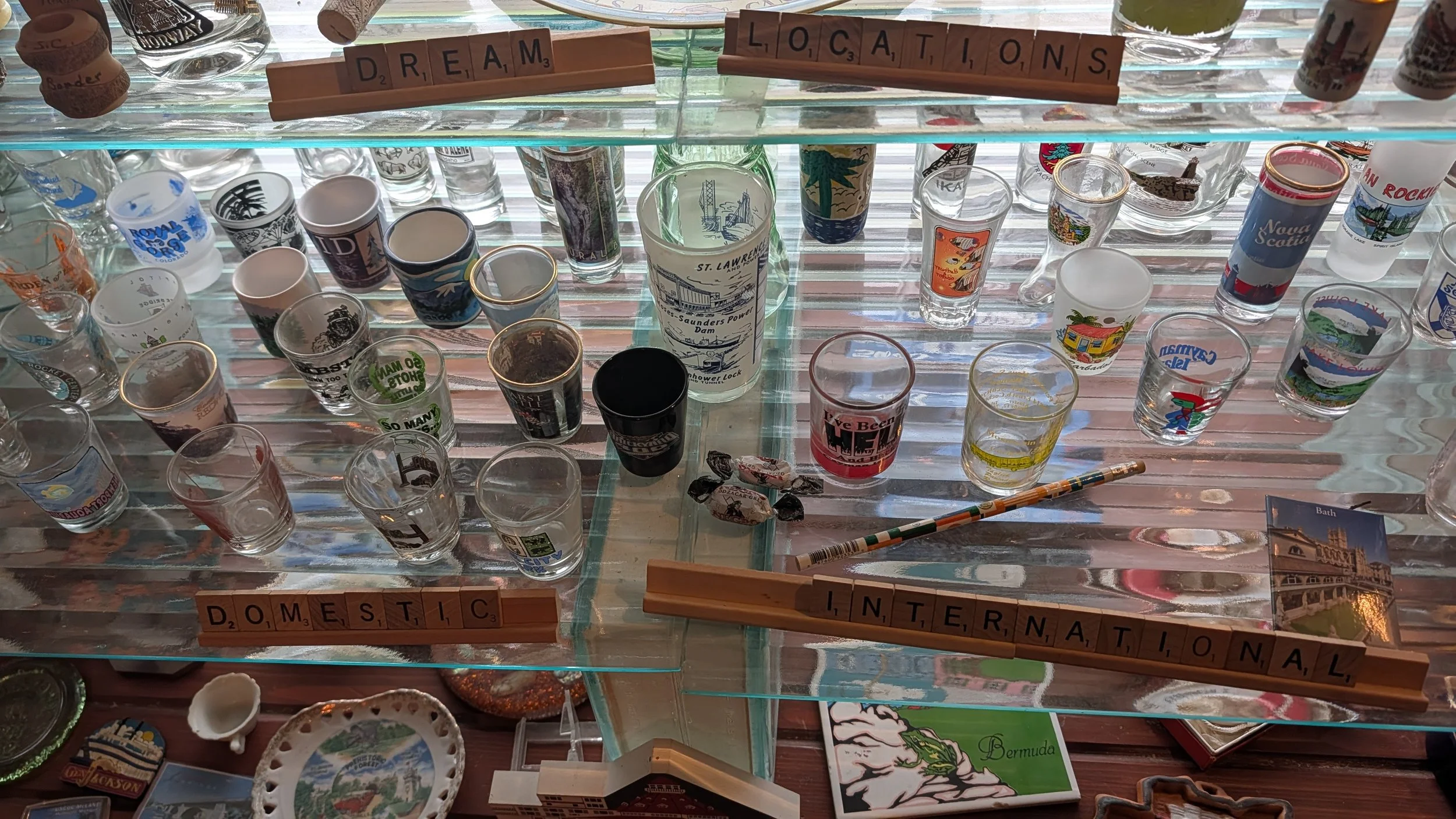 The bay window is filled with tacky souvenirs from places I have not yet been, I look for them at thrift stores 