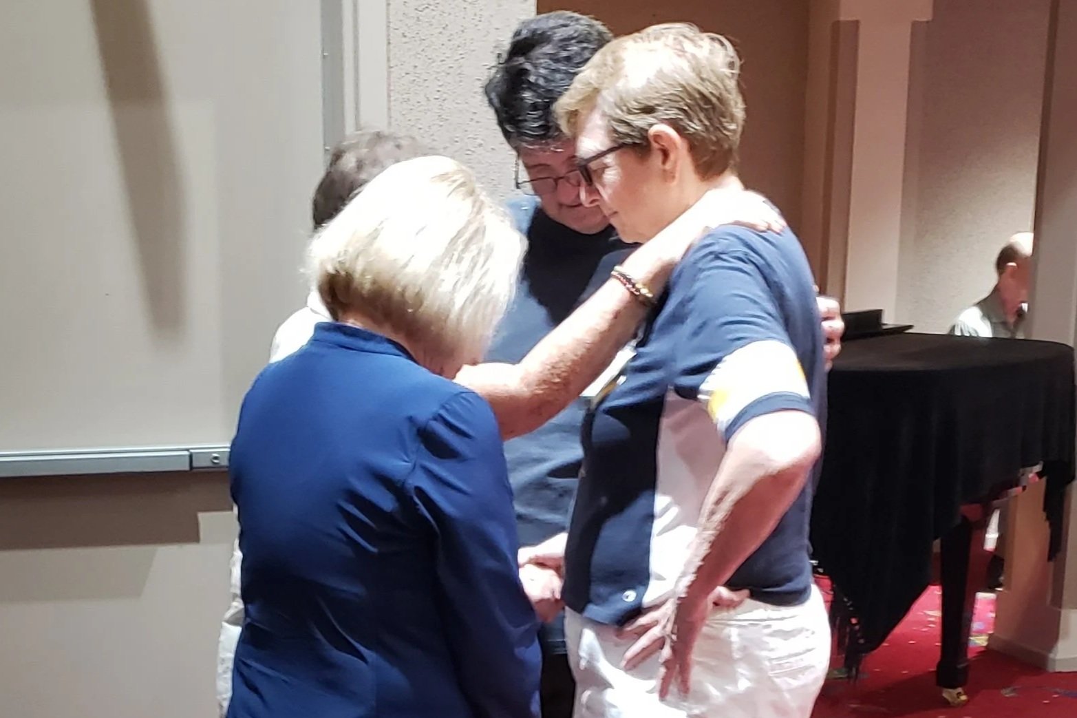 Congregation members gathered in a small prayer circle during Sunday service at St. Timothy's Episcopal Church in Henderson, NV.