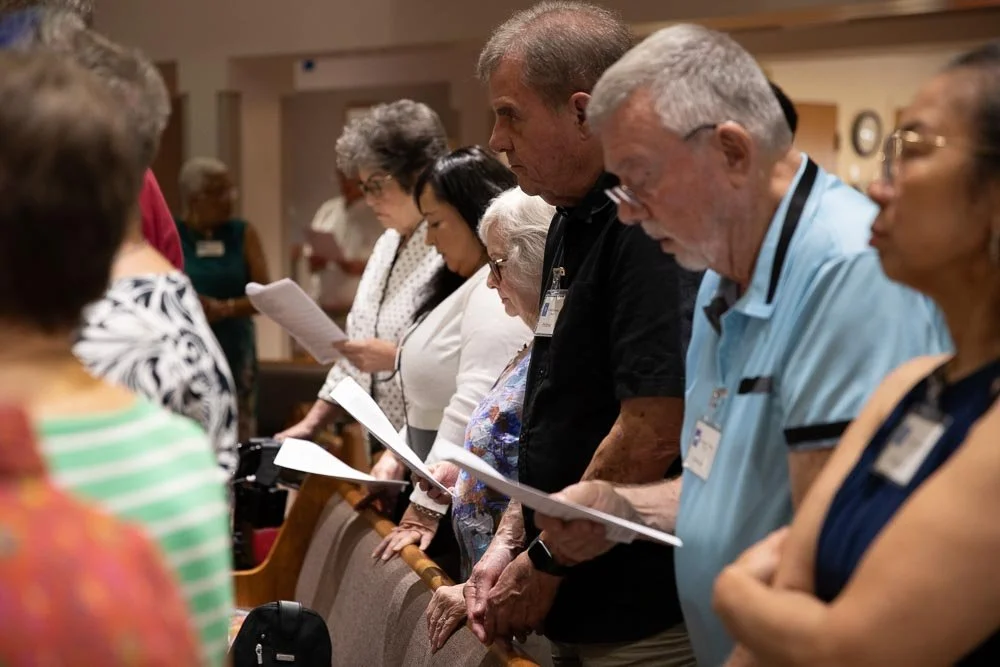 Members of the choir and congregation singing hymns in the sanctuary of St. Timothy's Episcopal Church in Henderson, NV.