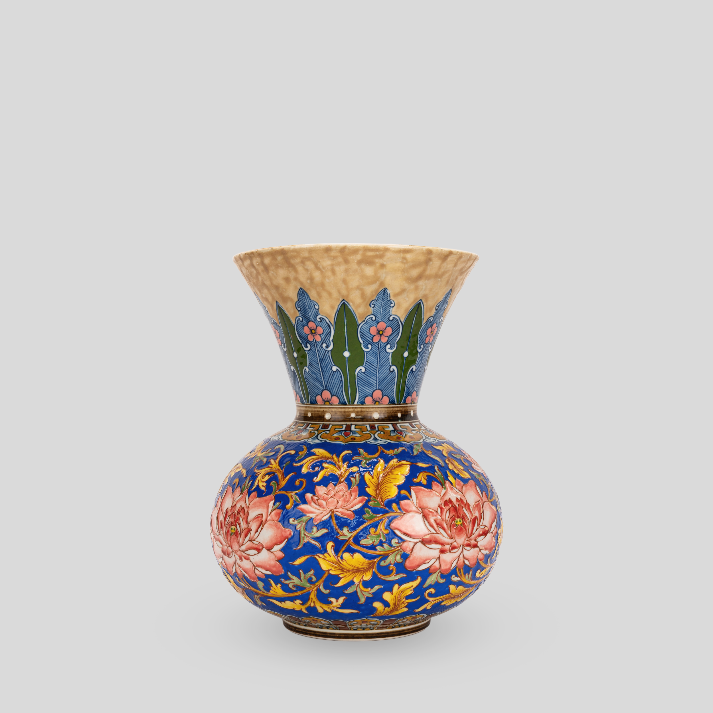 Colorful porcelain vase decorated with floral and leaf patterns in blue, pink, yellow, and green on a gray background.
