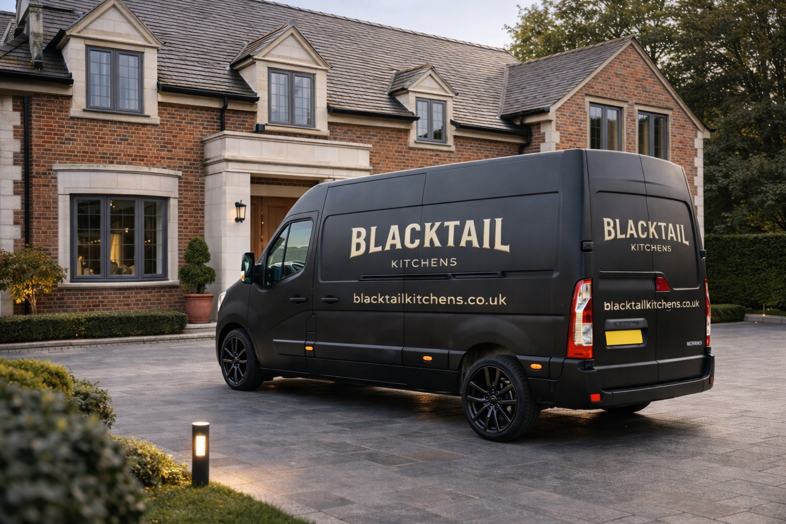 Blacktail Kitchens branded van parked outside a brick house.
