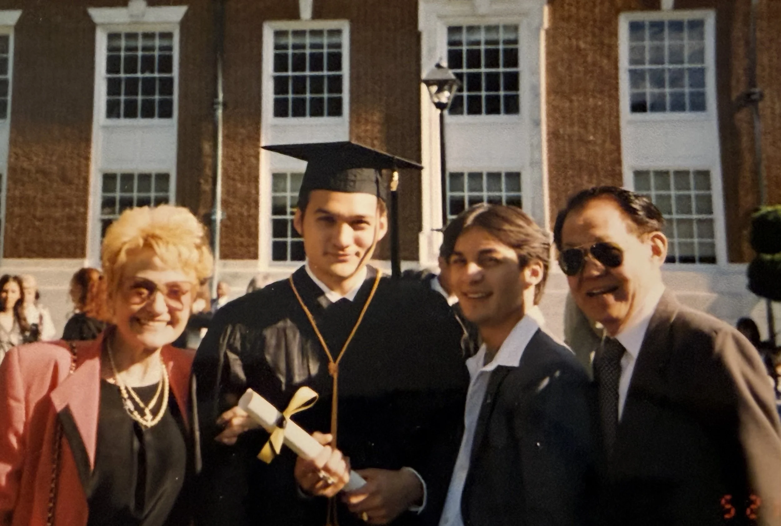 Wei-Li and his family celebrating his graduation from Law School in NYU. Wei-Li proudly holds his diploma.