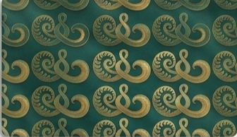 Pattern of gold and teal swirling designs on a surface.