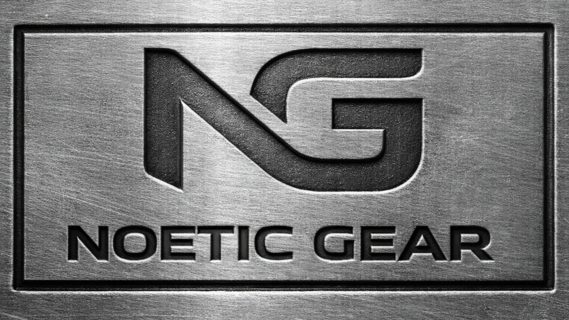 A metal plate with the Noetic Gear logo, a stylized 'N' and 'G' above the words 'NOETIC GEAR' engraved on it.