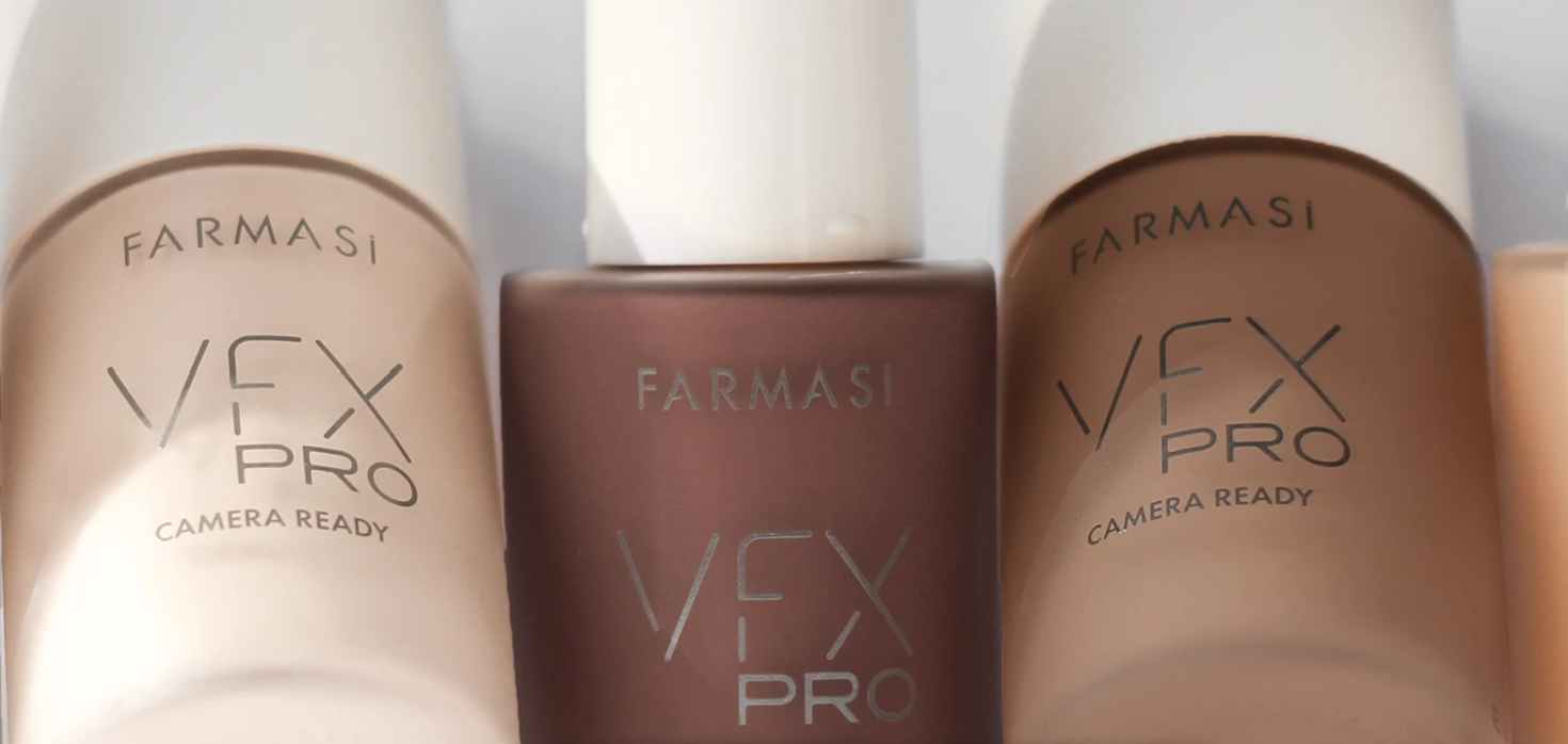 Three bottles of Farmasi VFX Pro makeup or skincare products on a white surface.
