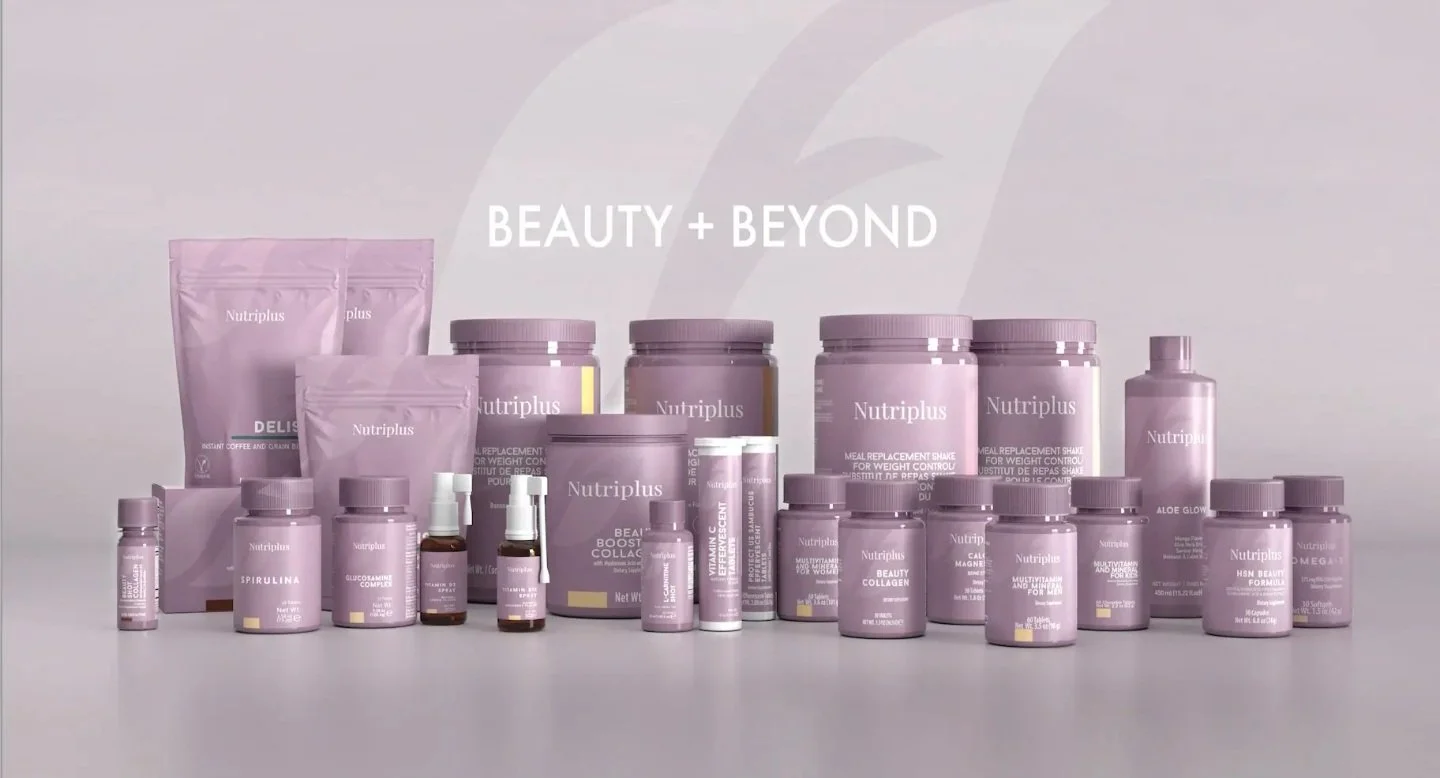 A variety of pink and purple Nutriplus health and beauty supplement products arranged on a white surface with the words 'BEAUTY + BEYOND' above them.
