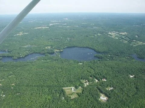 Aerial view of lake and surrounding towns.