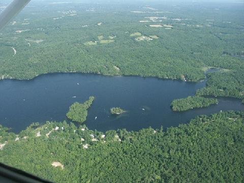 Aerial view of lake and surrounding land.