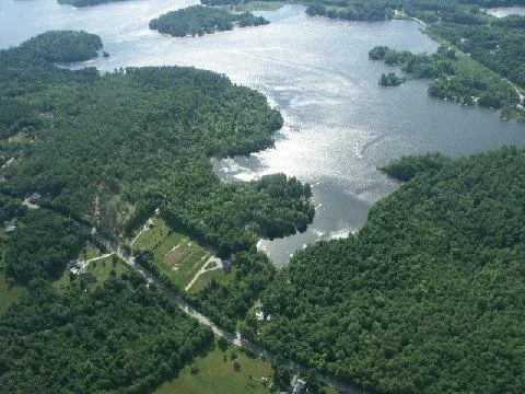 Aerial view of lake and surrounding land.