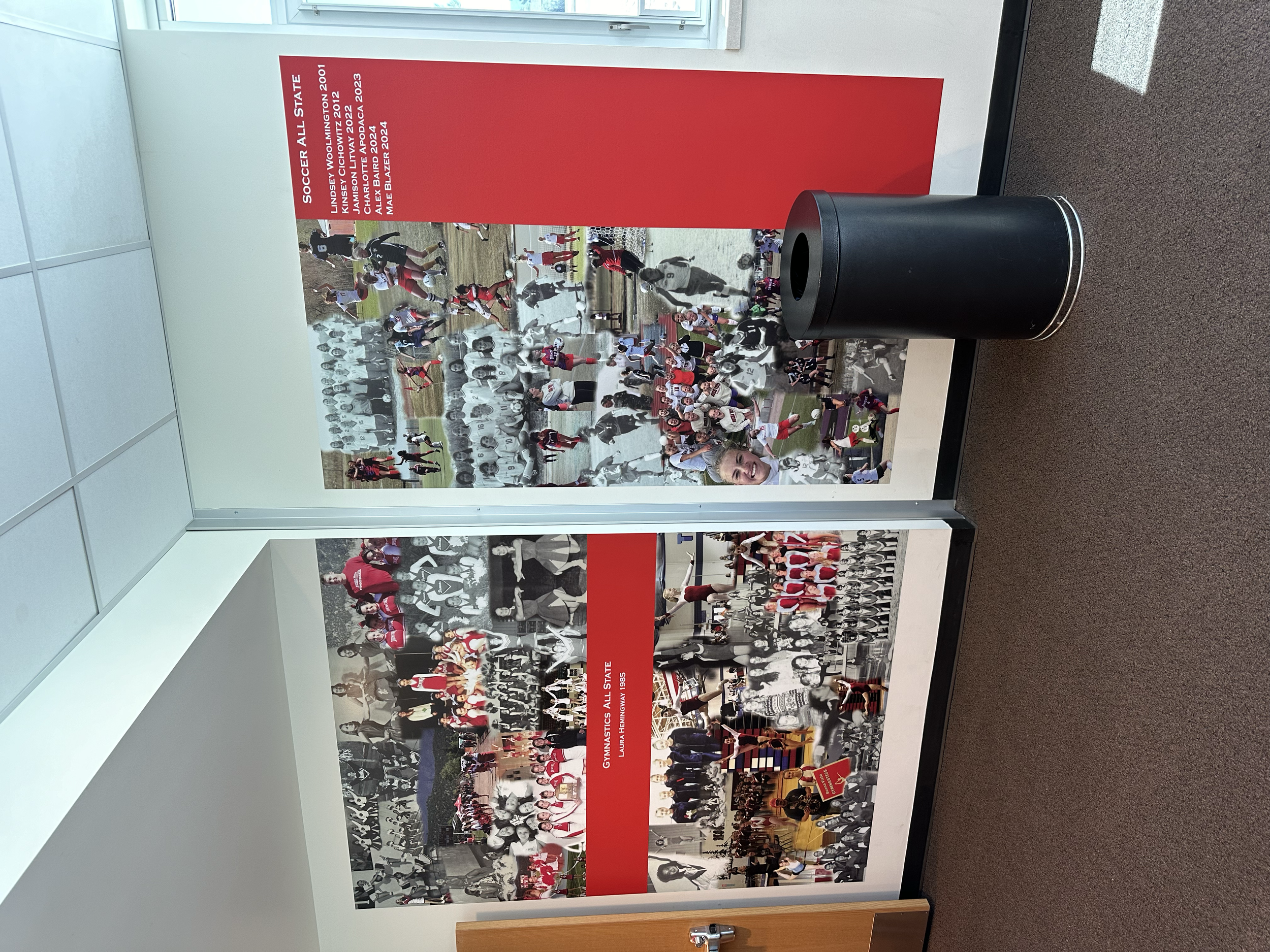 Display panel with historical photos of women's soccer and volleyball teams, highlighting their achievements and team photos.