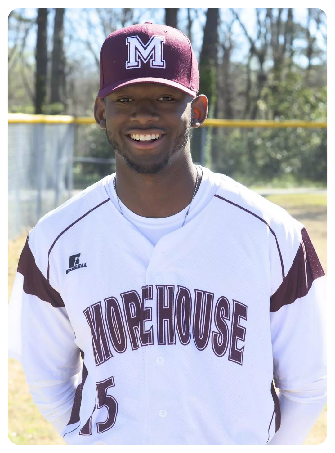 Plate of pasta with tomato sauce, grated cheese, and a basil leaf garnish on a wooden table.