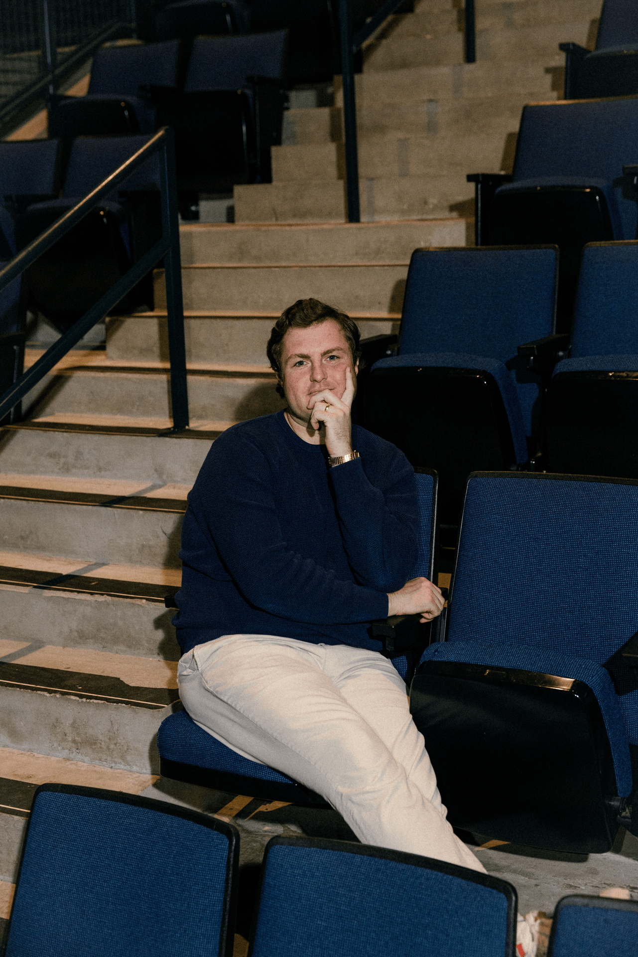 Multiple images of the social team quickly flashing by as they sit posing in the bleachers of a gymnasium.