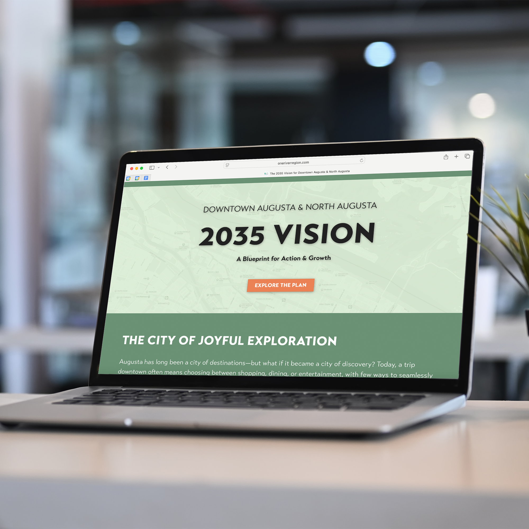 A laptop with the screen showing the 2035 Vision of Downtown Augusta and North Augusta blueprint website.