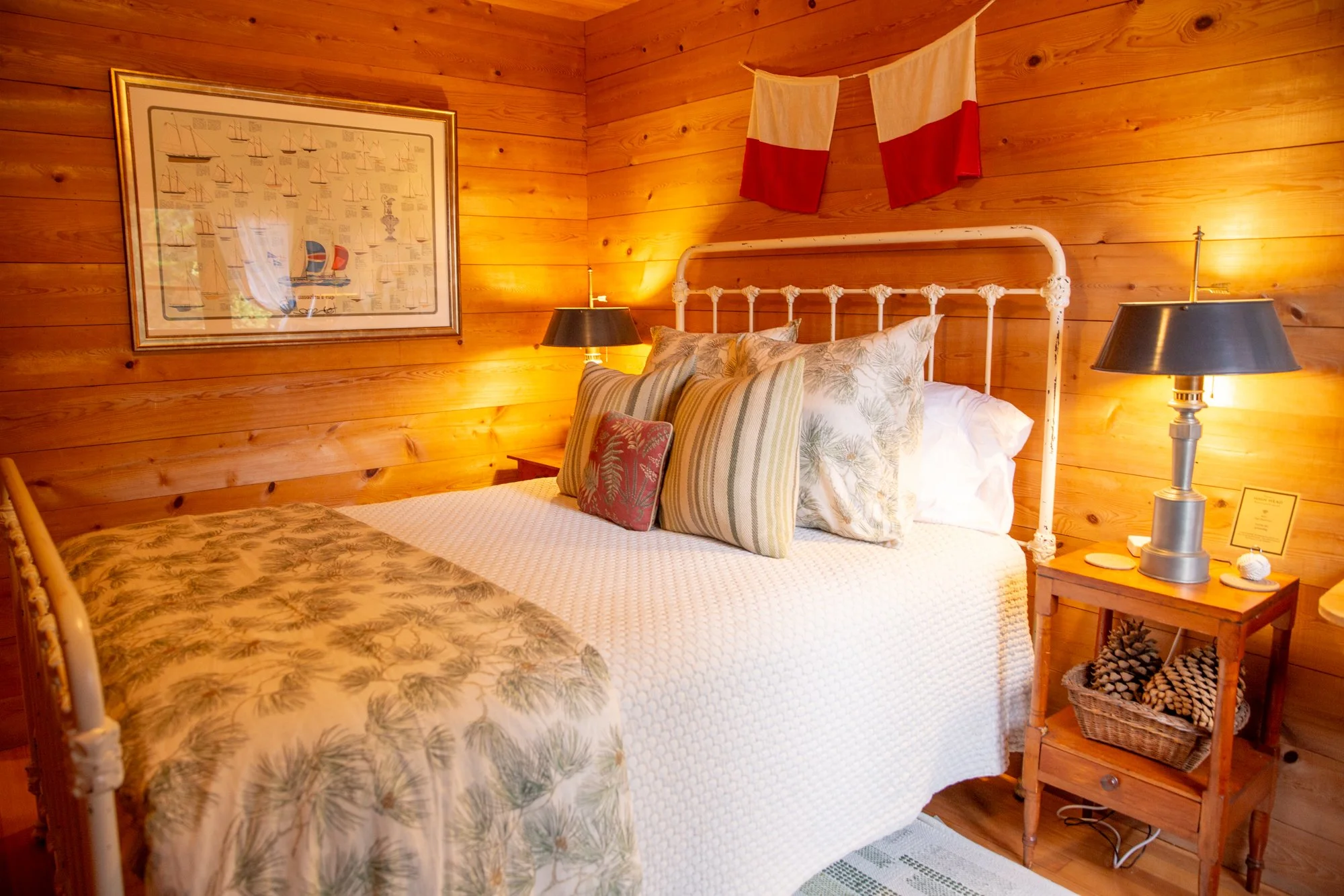 high-head-brooklin-maine-bedroom-nautical-chart-artwork-iron-bed-pine-walls.jpg