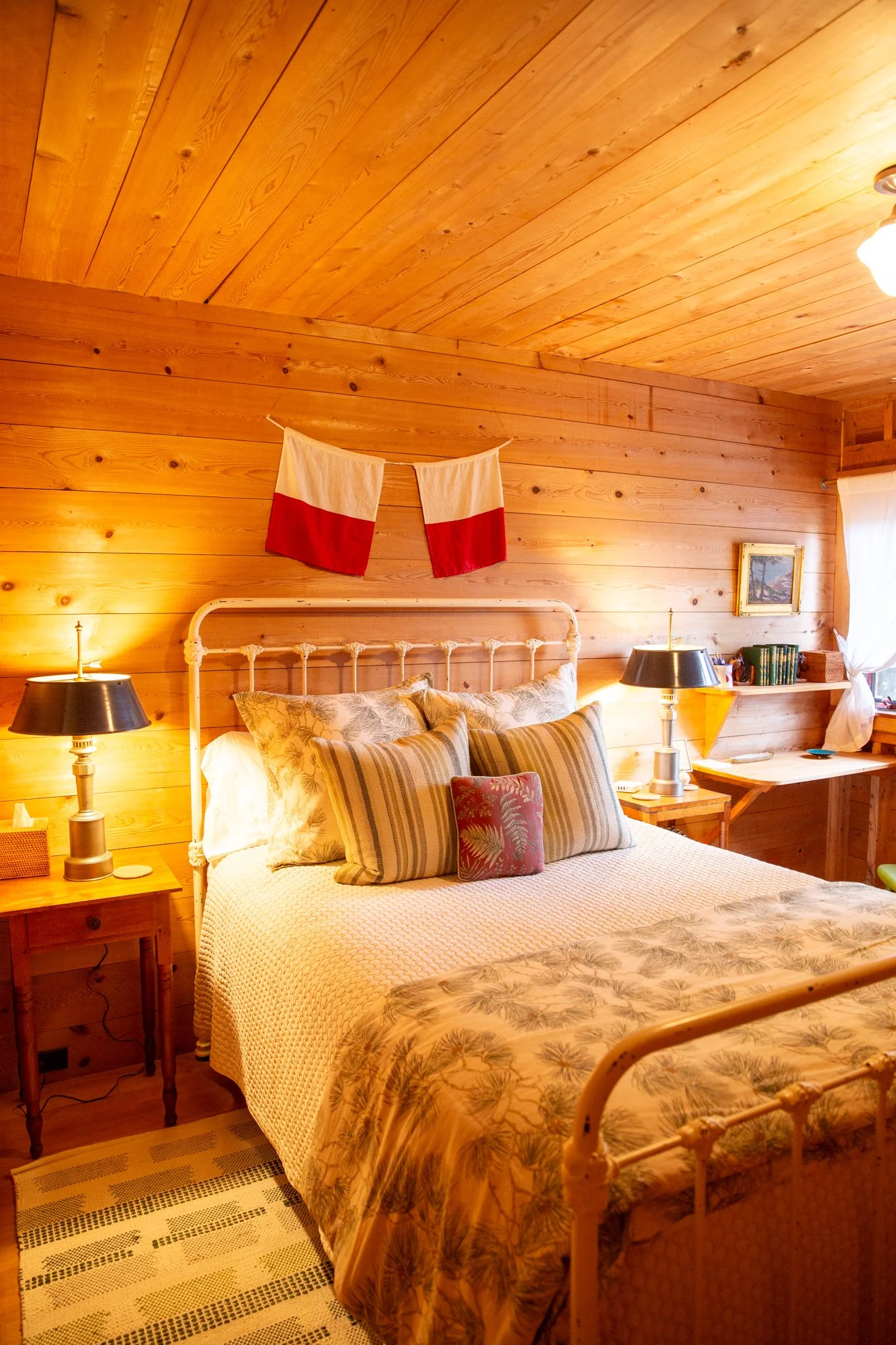 high-head-brooklin-maine-bedroom-nautical-flags-iron-bed-pine-walls.jpg