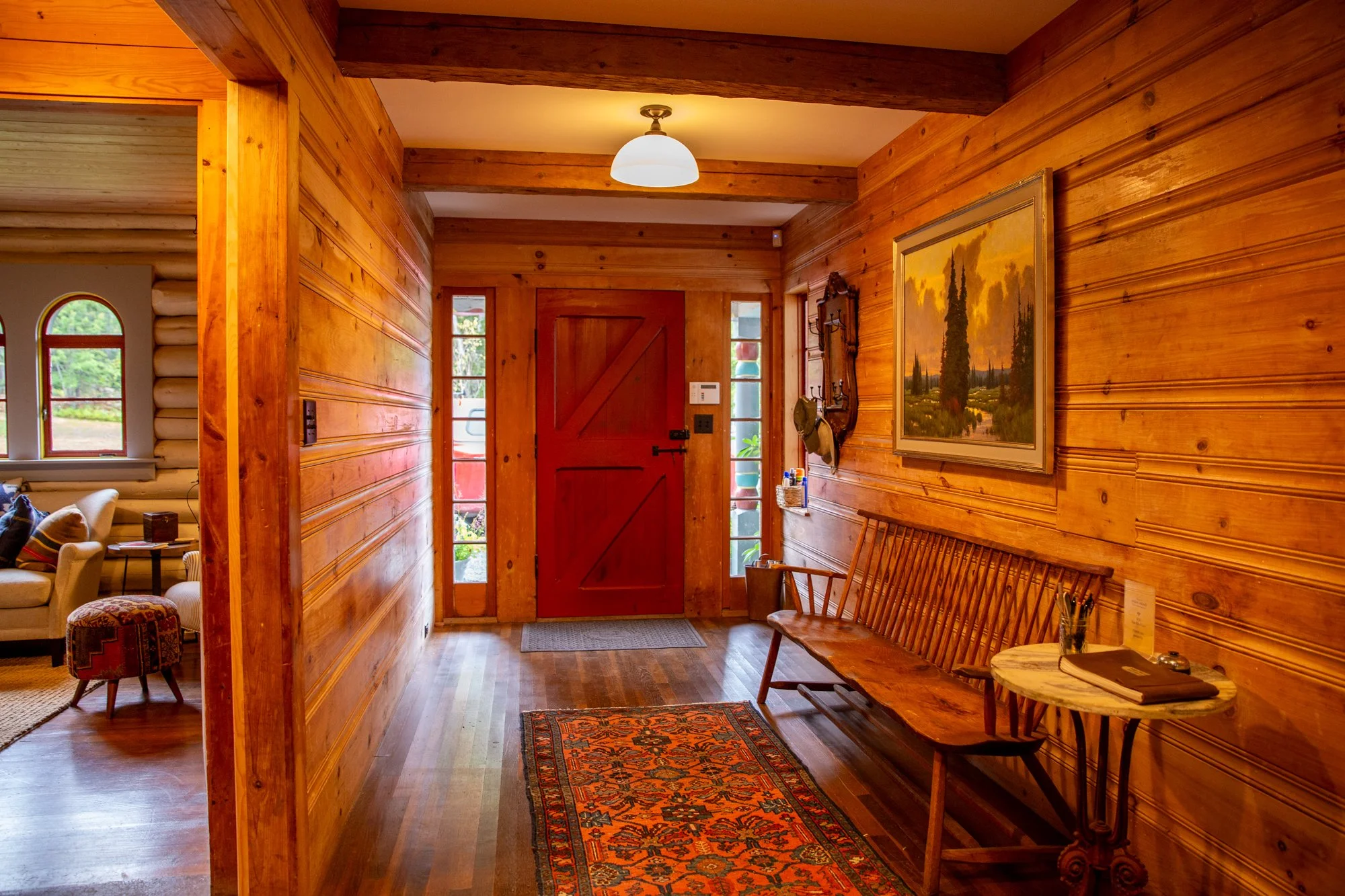 high-head-brooklin-maine-entryway-foyer-red-barn-door-hardwood-floors-bench.jpg