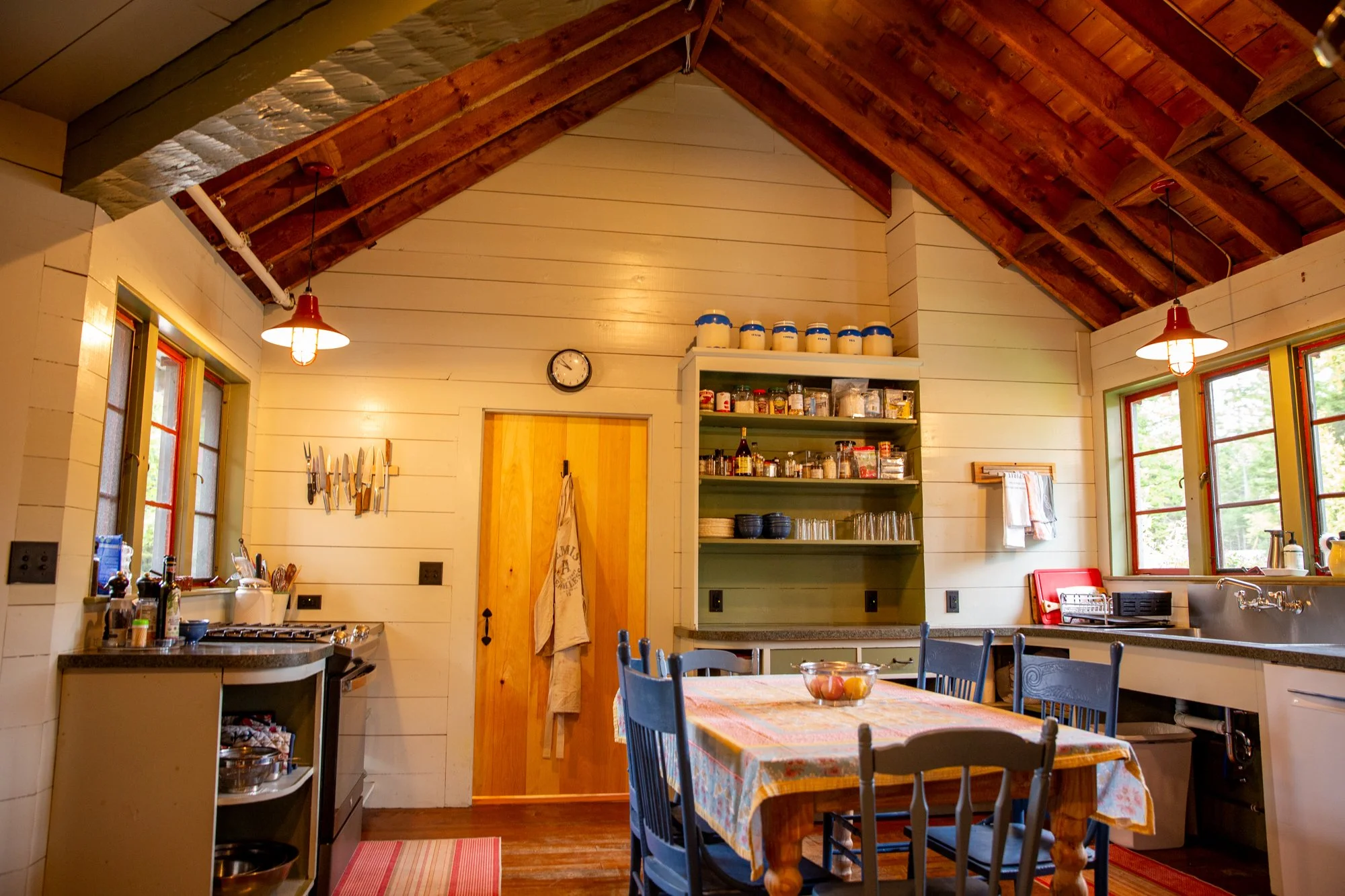 high-head-brooklin-maine-kitchen-vaulted-ceiling-farmhouse-table-open-shelving.jpg