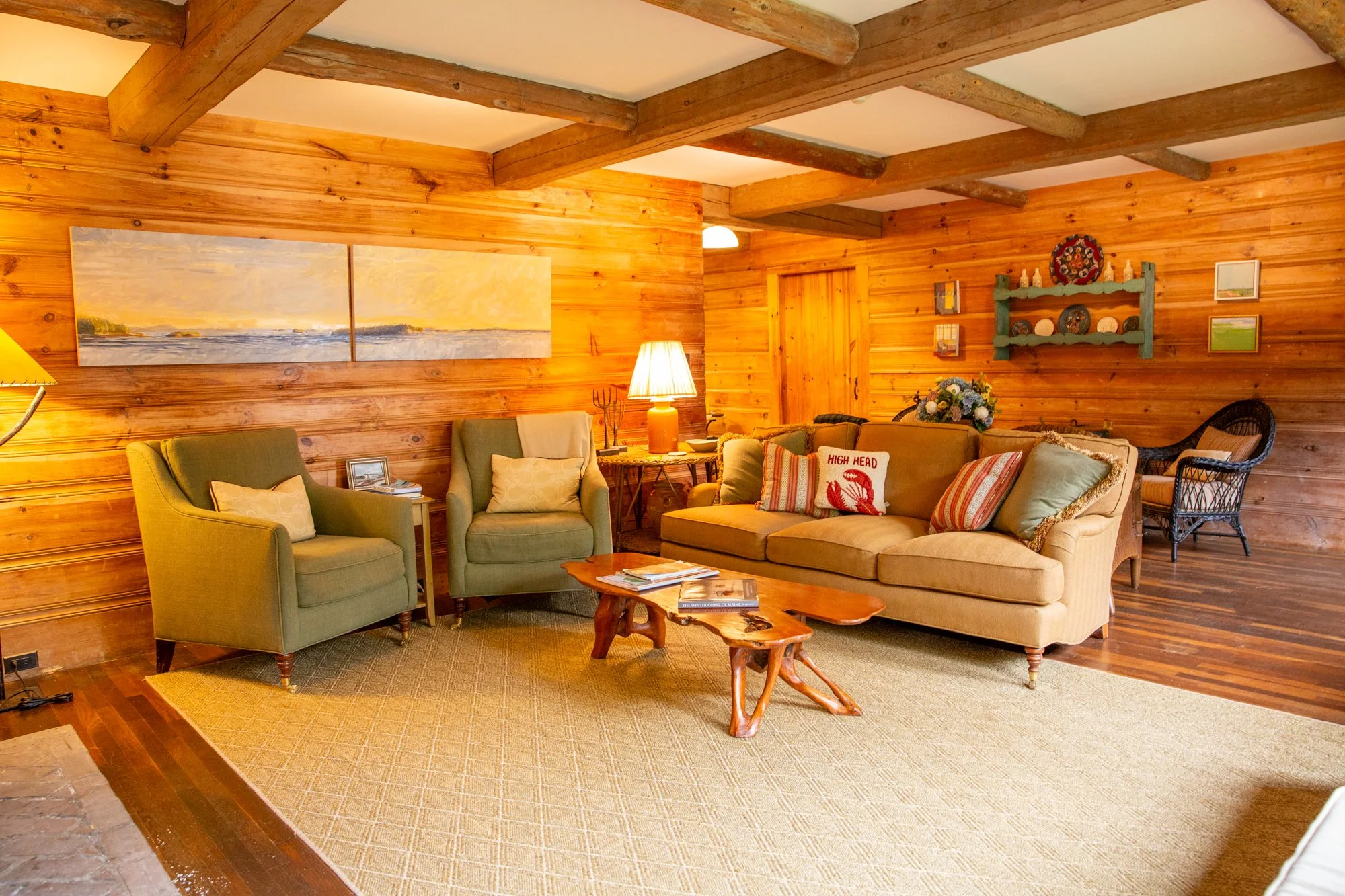 high-head-brooklin-maine-living-room-wood-paneled-sofa-coastal-artwork.jpg