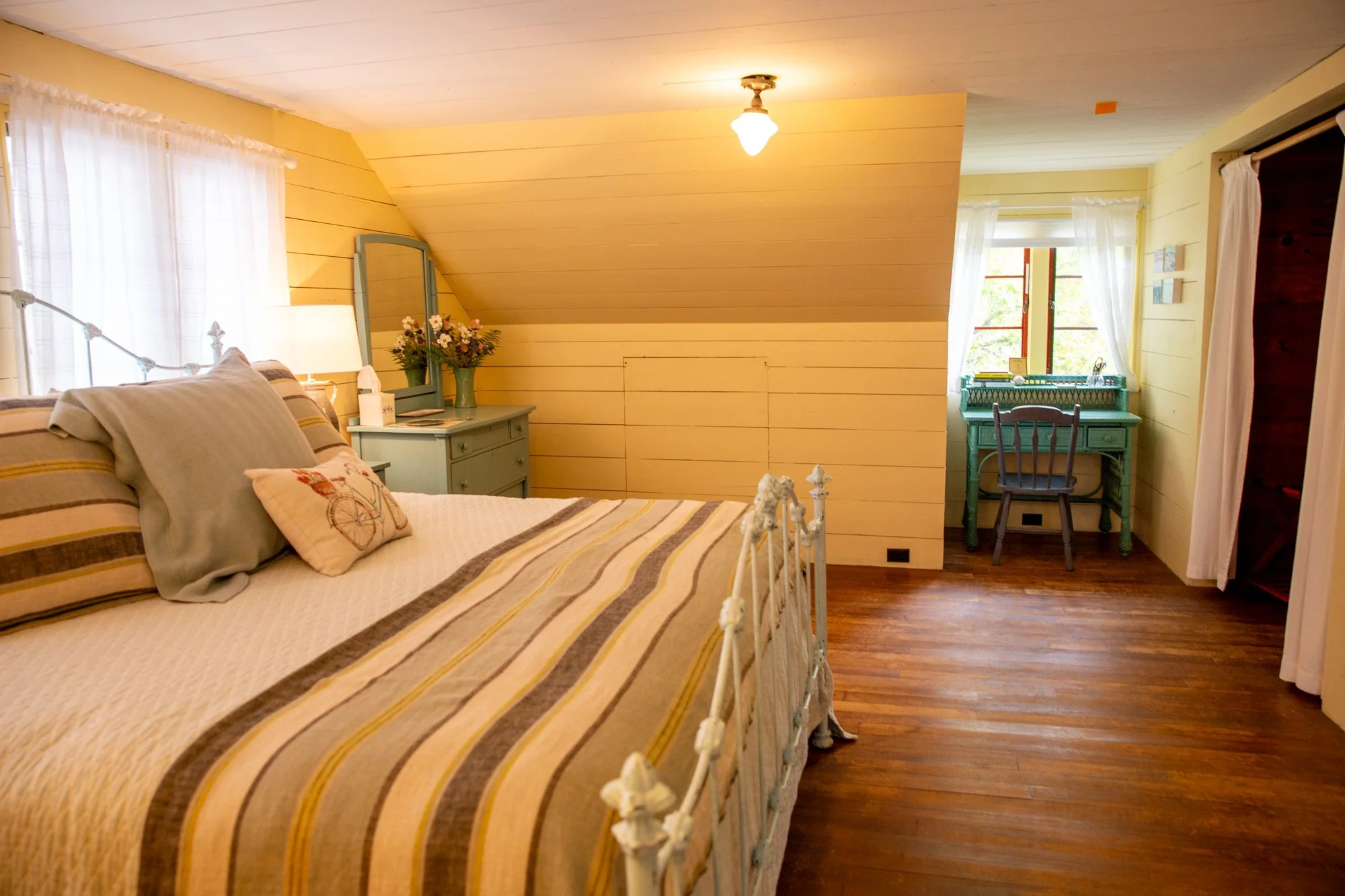 high-head-brooklin-maine-loft-bedroom-writing-desk-yellow-walls-hardwood-floors.jpg