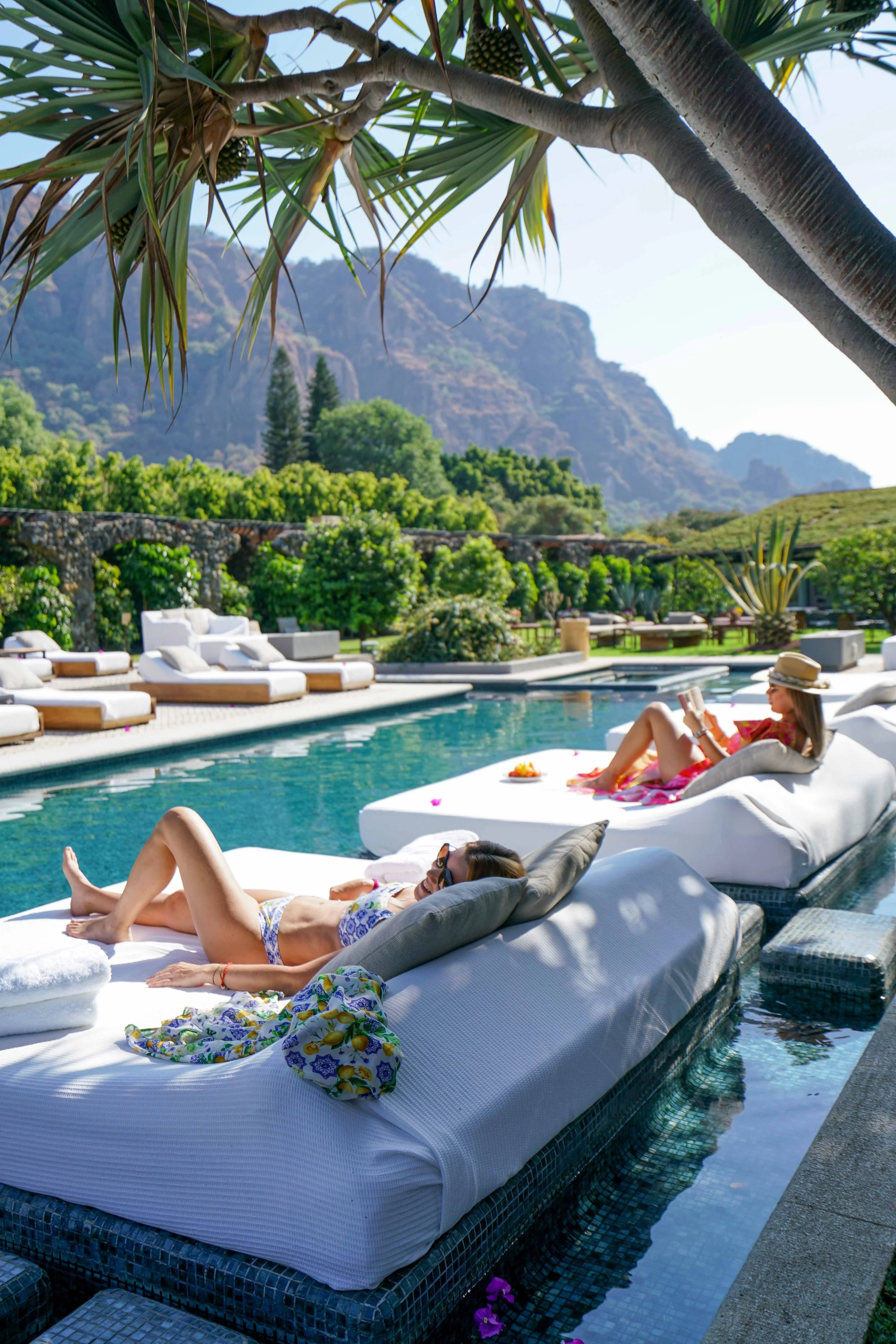 sunlit relaxation time by the pool photographed by best travel photographer for resort client