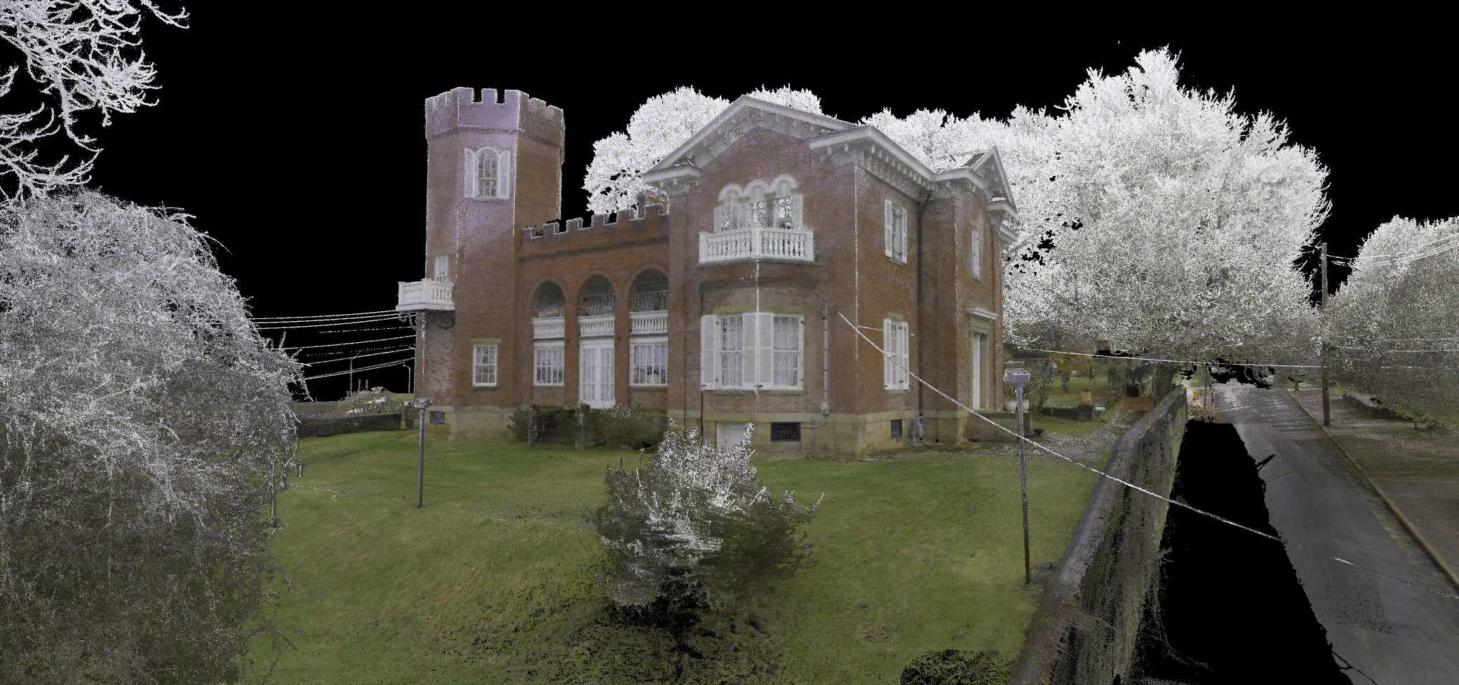 A large, historic brick house with a tower, surrounded by trees and a road, rendered with an upside-down color effect.