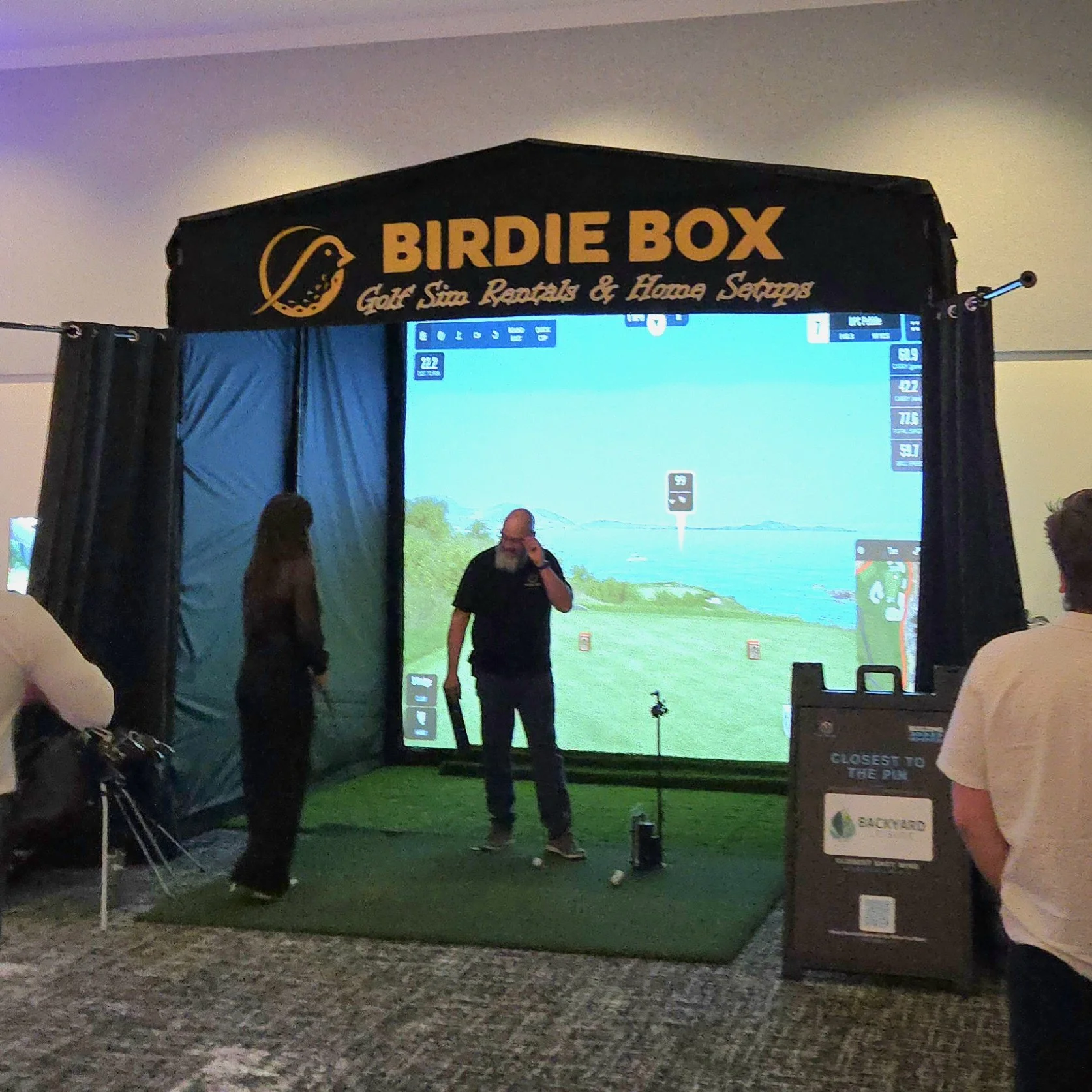 Woman in the Birdie Box Golf simulator