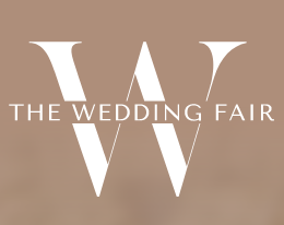 Logo for The Wedding Fair with a large stylized letter 'W' and the text 'The Wedding Fair' on a beige background.