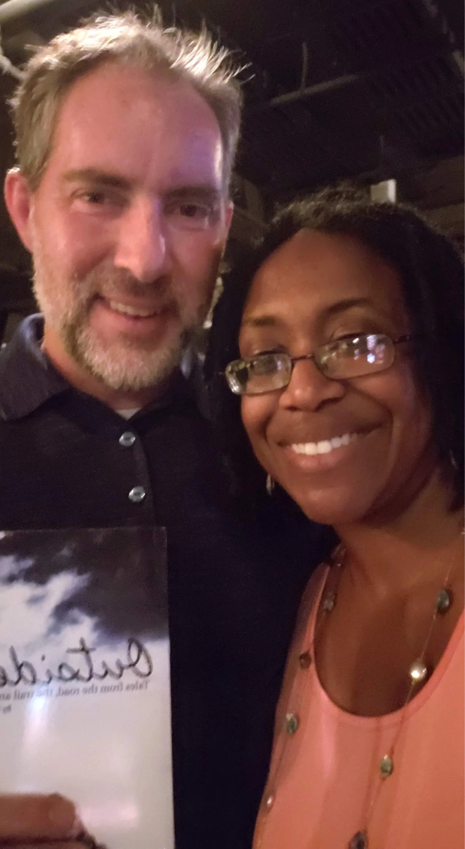Sharryn Dotson smiling with an author Bob Doucette. 