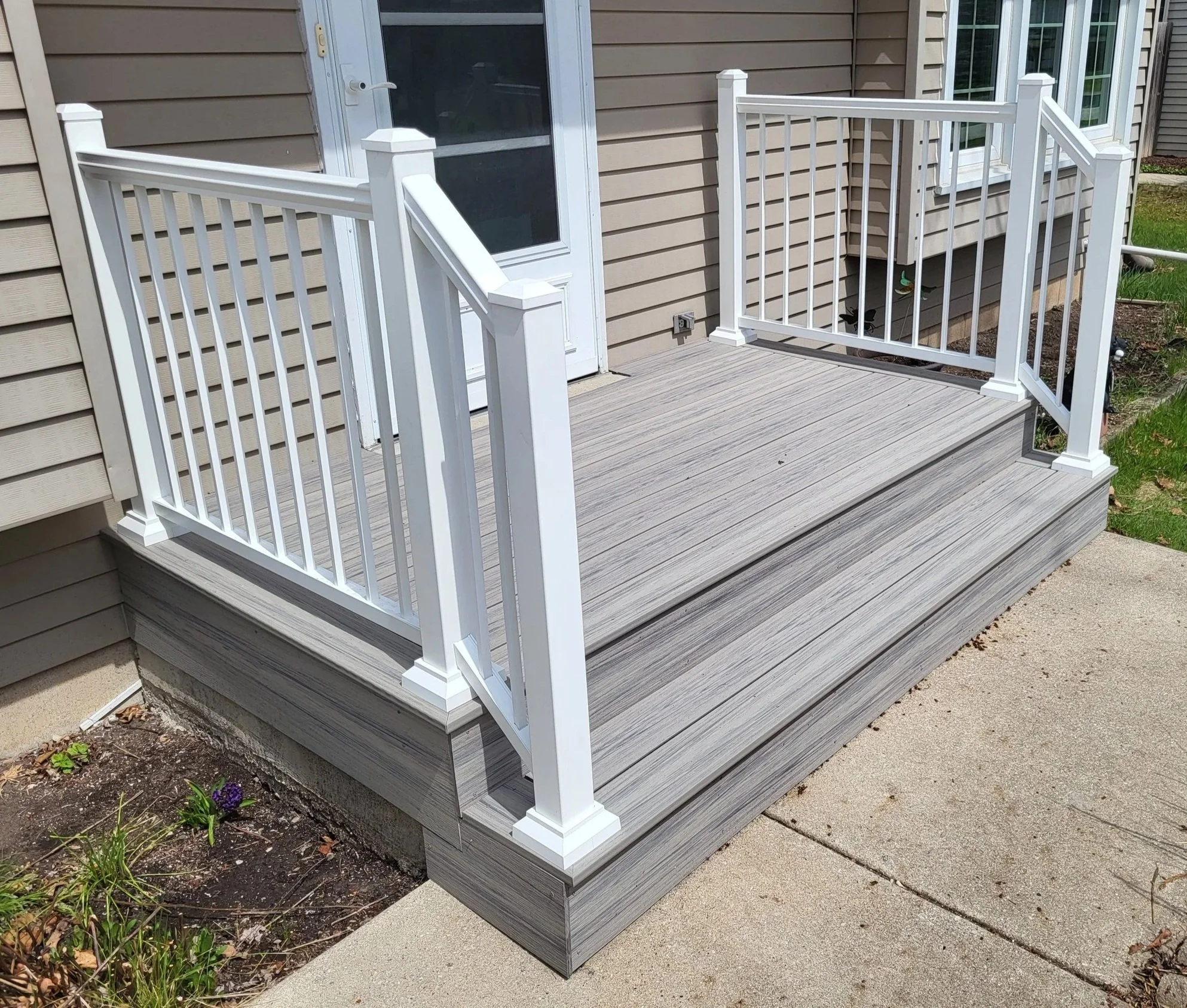 After - a "deck over" project complete with Timbertech Advanced PVC deck boards and Williams aluminum railings.  The end project was not only much safer, but added a ton of curb appeal!