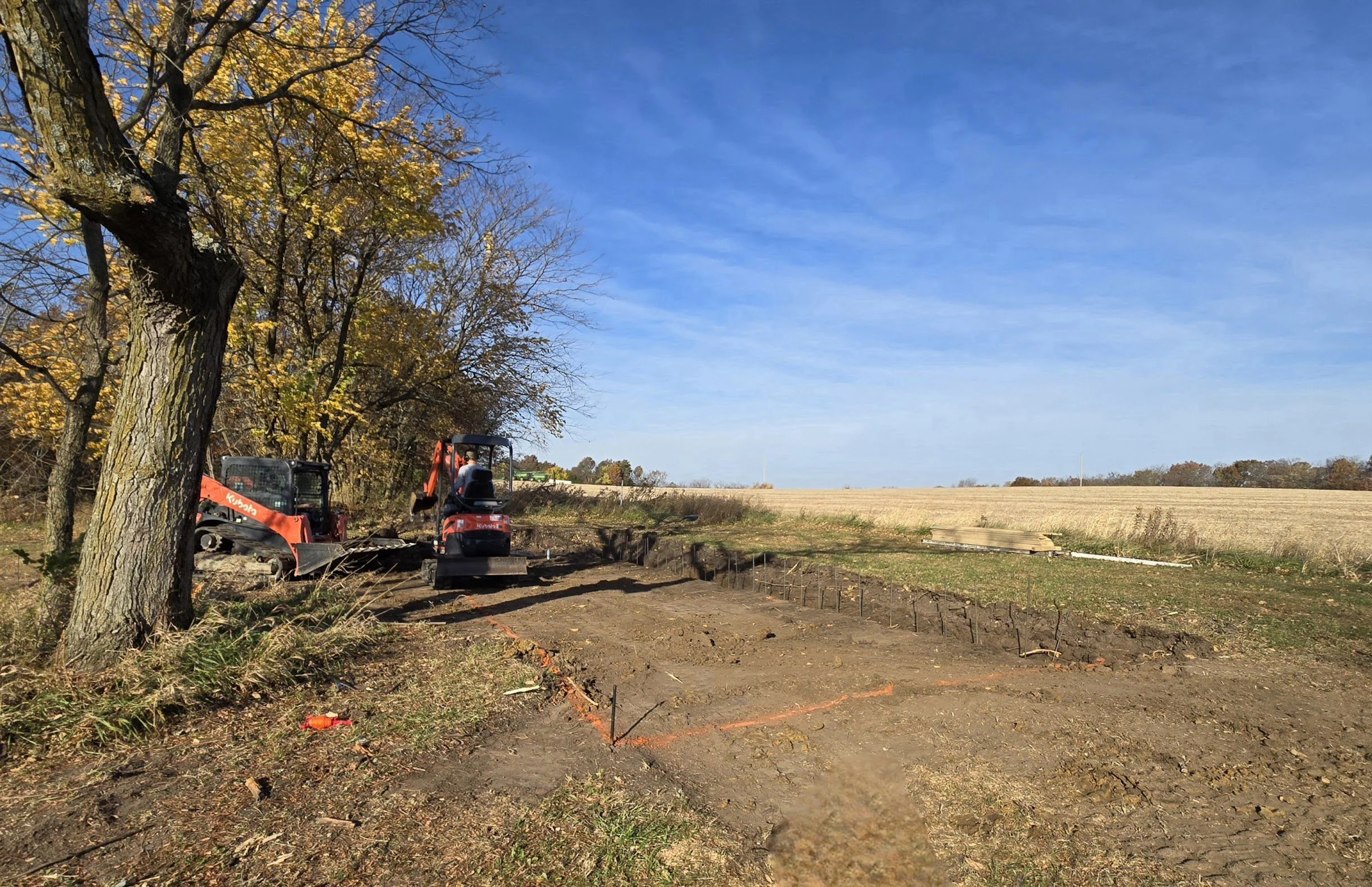 Excavator and skid steer prepping build site in Brookfield, Missouri.
