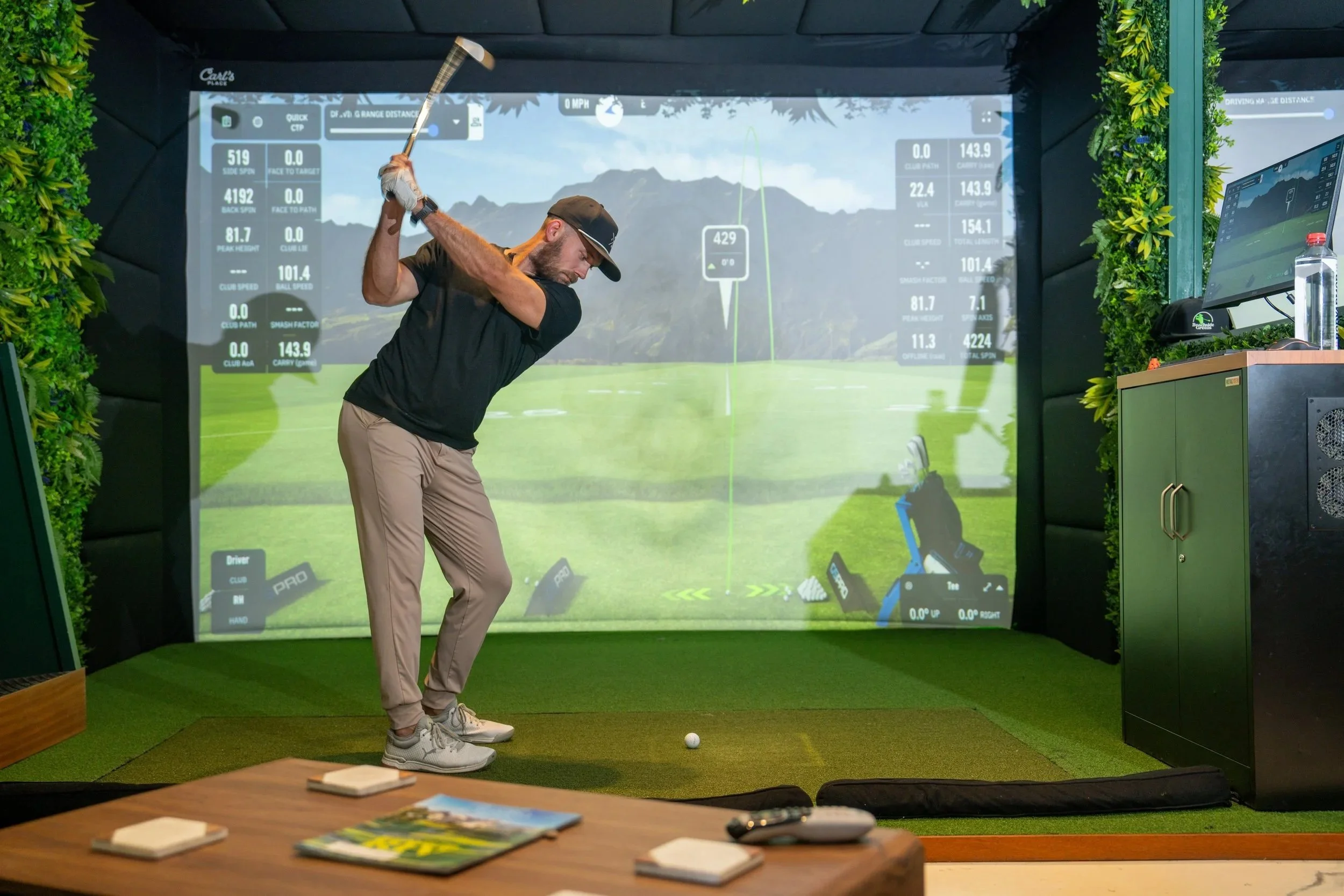 Golfer practicing at Beachside Greens indoor golf simulator studio in Pacific Beach San Diego